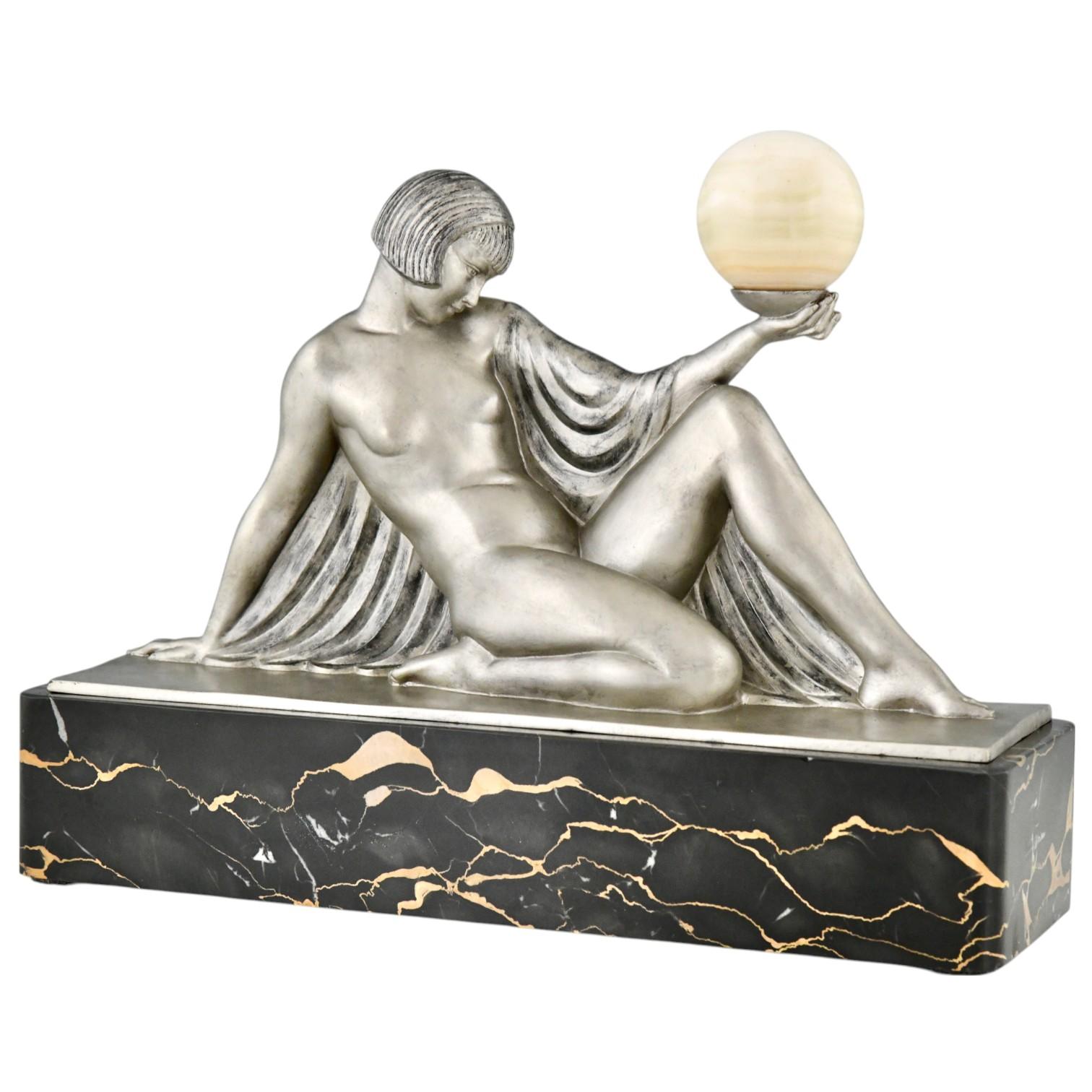 Rèverie Art Deco sculpture seated lady holding a ball by Raymonde Guerbe for Max Le Verrier. 
Art metal sculpture with silver patina mounted on a Portor marble base, onyx ball. 
France 1930.
This sculpture is illustrated in:
Max le Verrier, un
