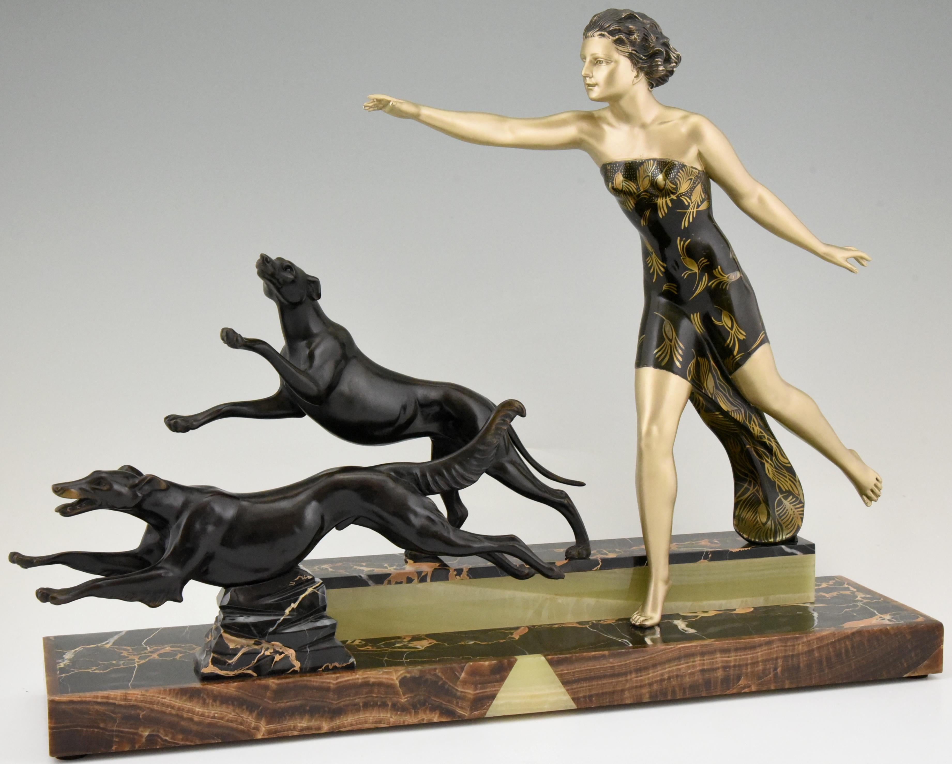 Spectacular Art Deco sculpture lady with dogs, her dress is decorated with flowers. The piece signed by Uriano, an Italian artist who worked in France.
The sculpture is mounted on a fine onyx and marble base, circa 1930.