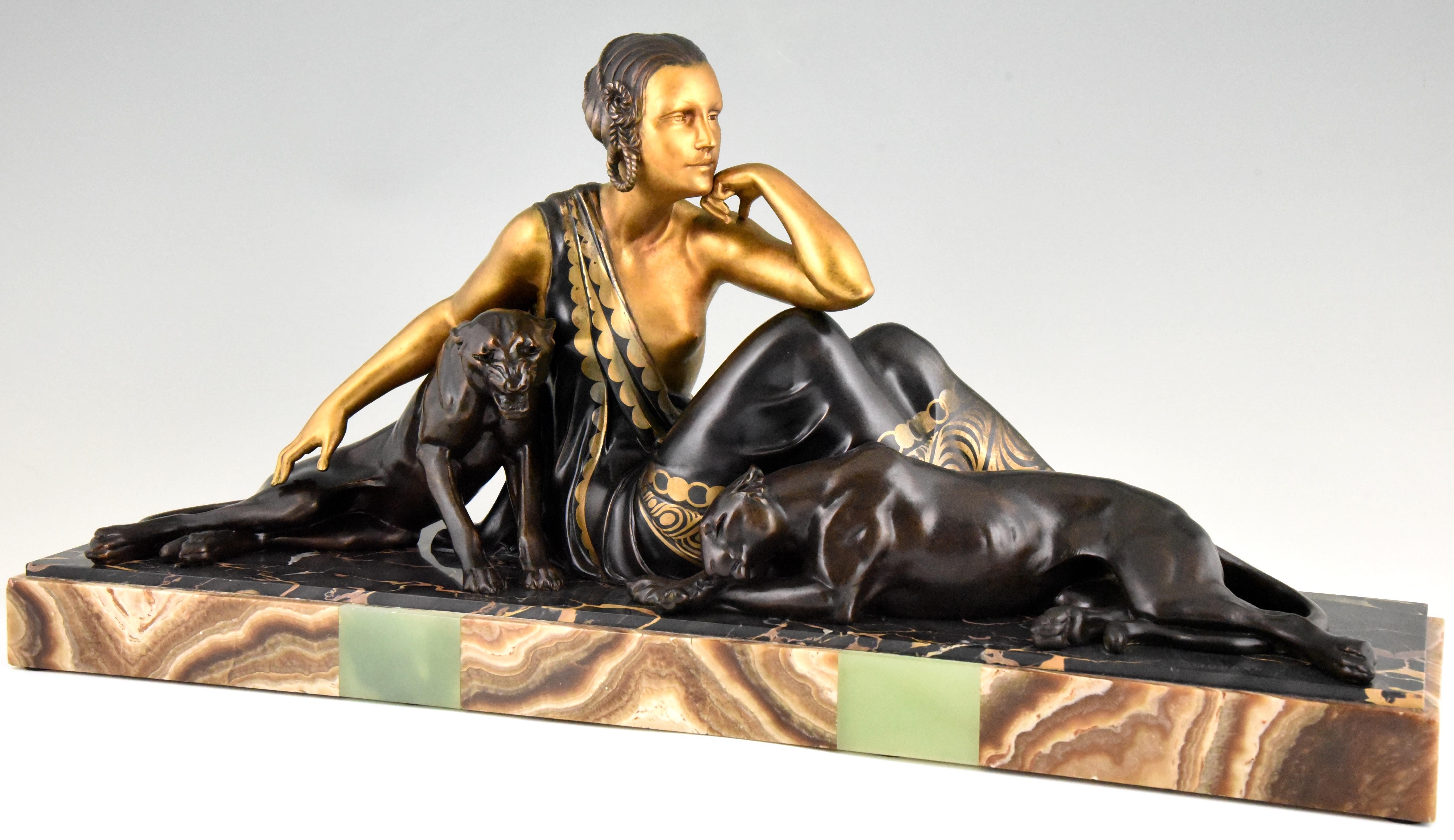 Impressive Art Deco group of a lady with two panthers. This large sculpture has a lovely patina and is mounted on a beautiful marble base. This version with two panthers is very hard to find. Signed by the French artist Armand Godard, circa