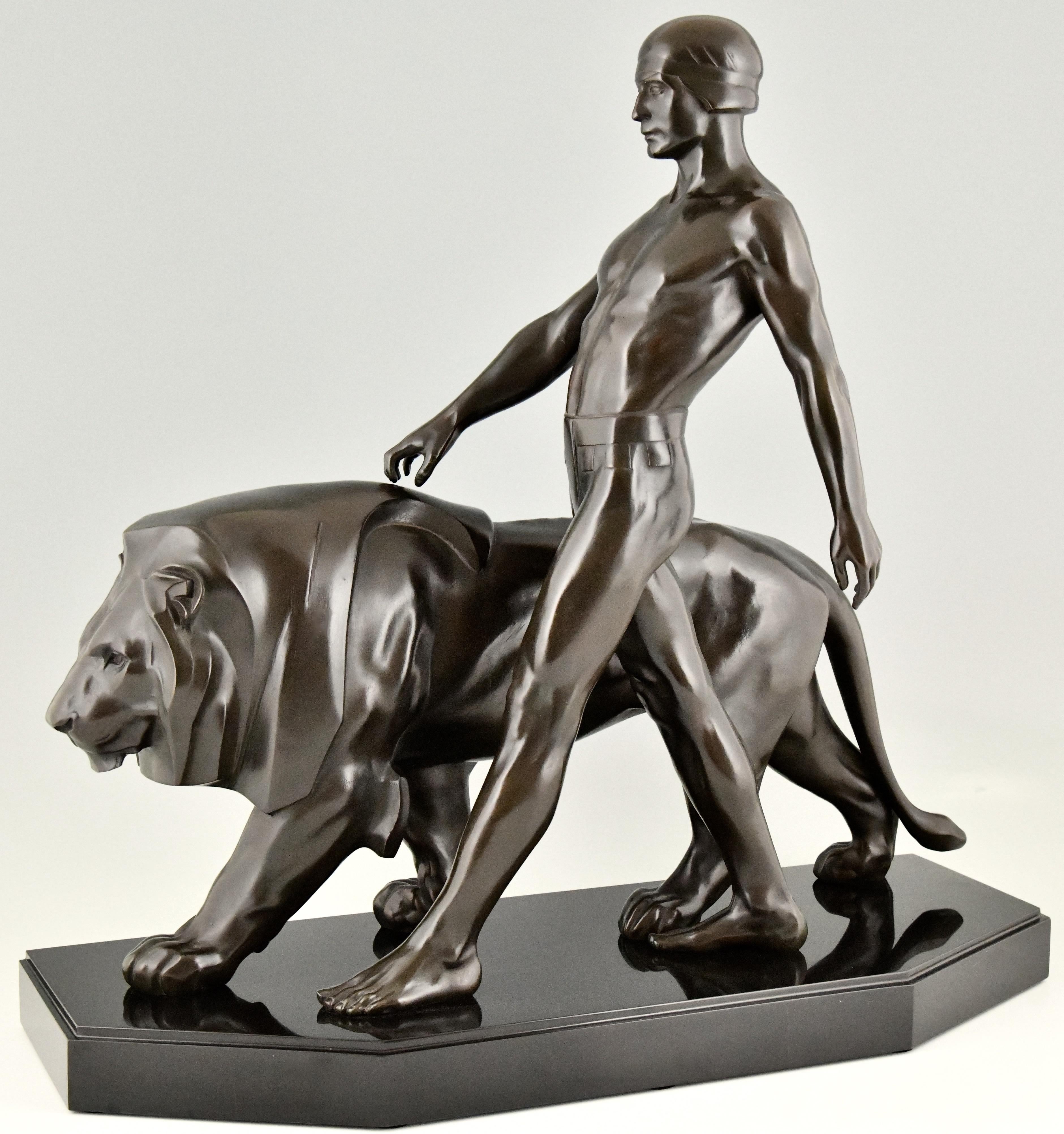 Belluaire, impressive Art Deco sculpture of a Lion tamer or Galdiator walking with a lion by the French sculptor Max Le Verrier, 1930. The Art Metal sculpture has a beautiful dark green patina and stands on a Belgian black marble base. 

This