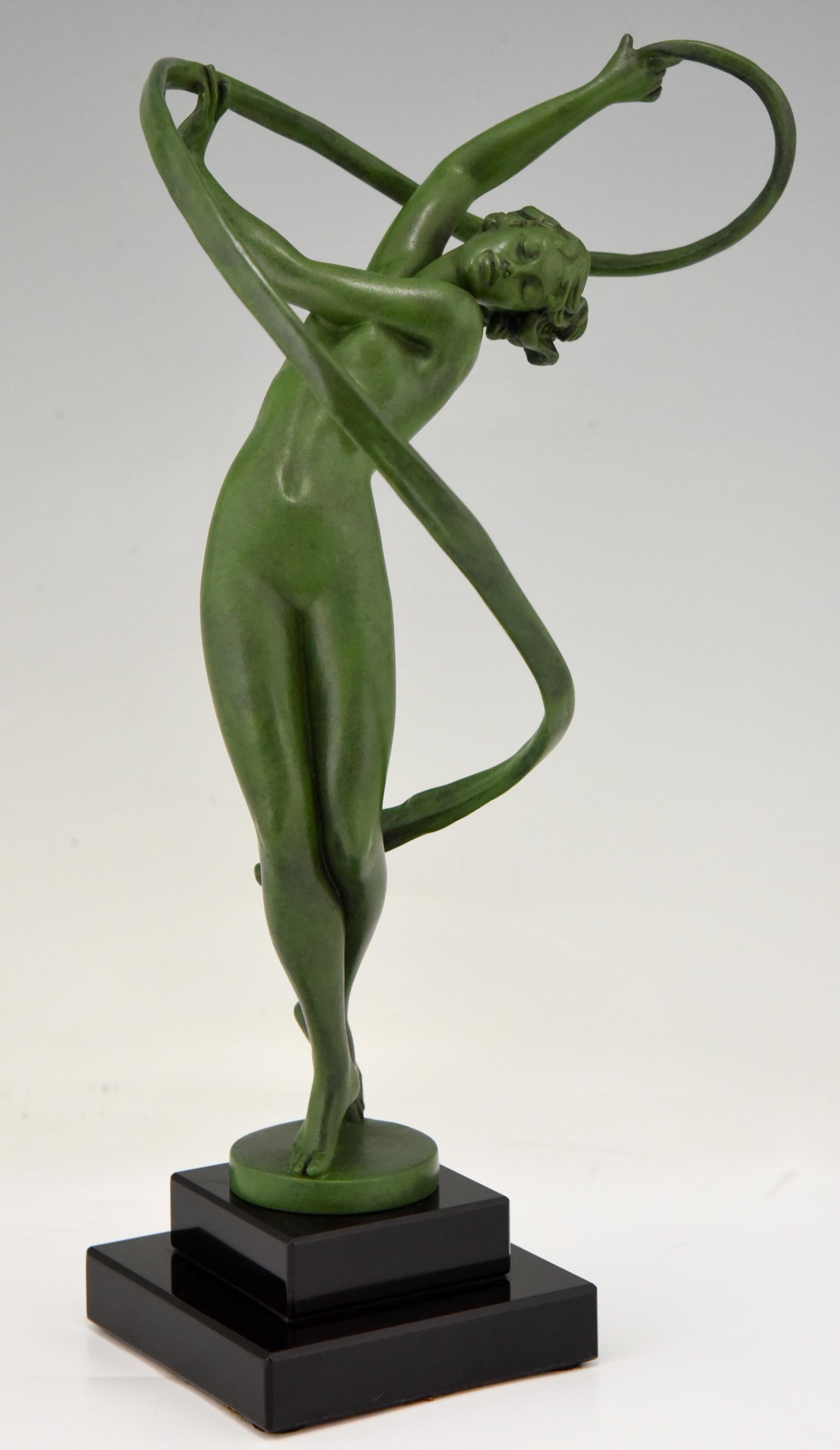 Tourbillon, elegant Art Deco sculpture of a nude dancer with swirling ribbon by Fayral, pseudonym of Pierre Le Faguays.
Cast at the Max Le Verrier foundry in Paris, circa 1930.
The art metal sculpture has a green patina and stands on a Belgian