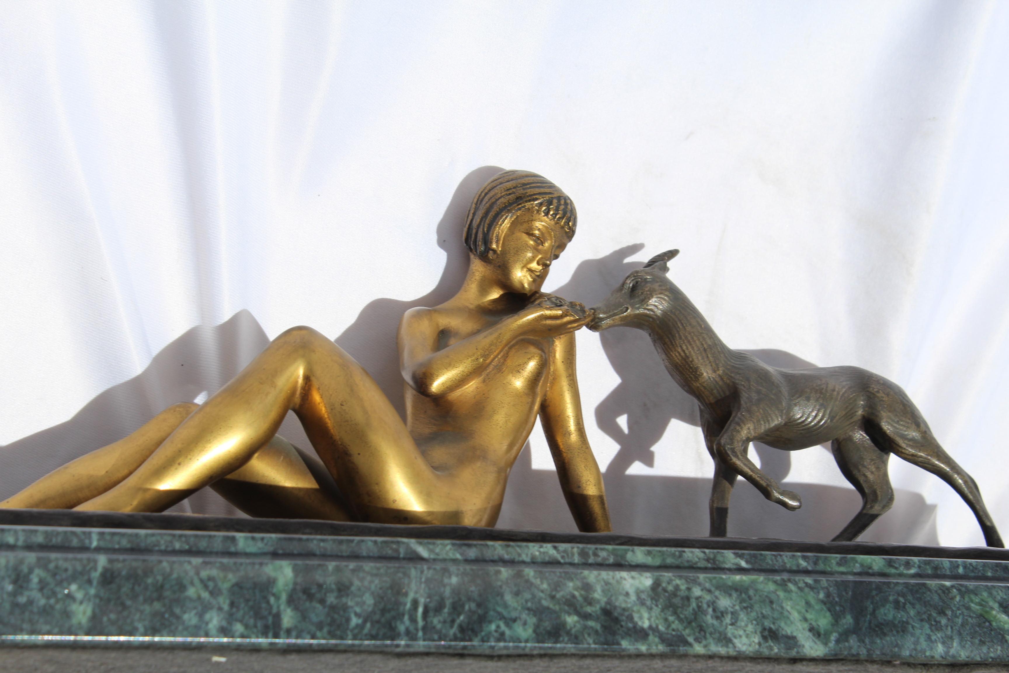 Young girl nude feeding a goat. Has doré gold patina. Mounted on dark green marble. Signed by the French artist (Renaud) heavy at 17 1/2