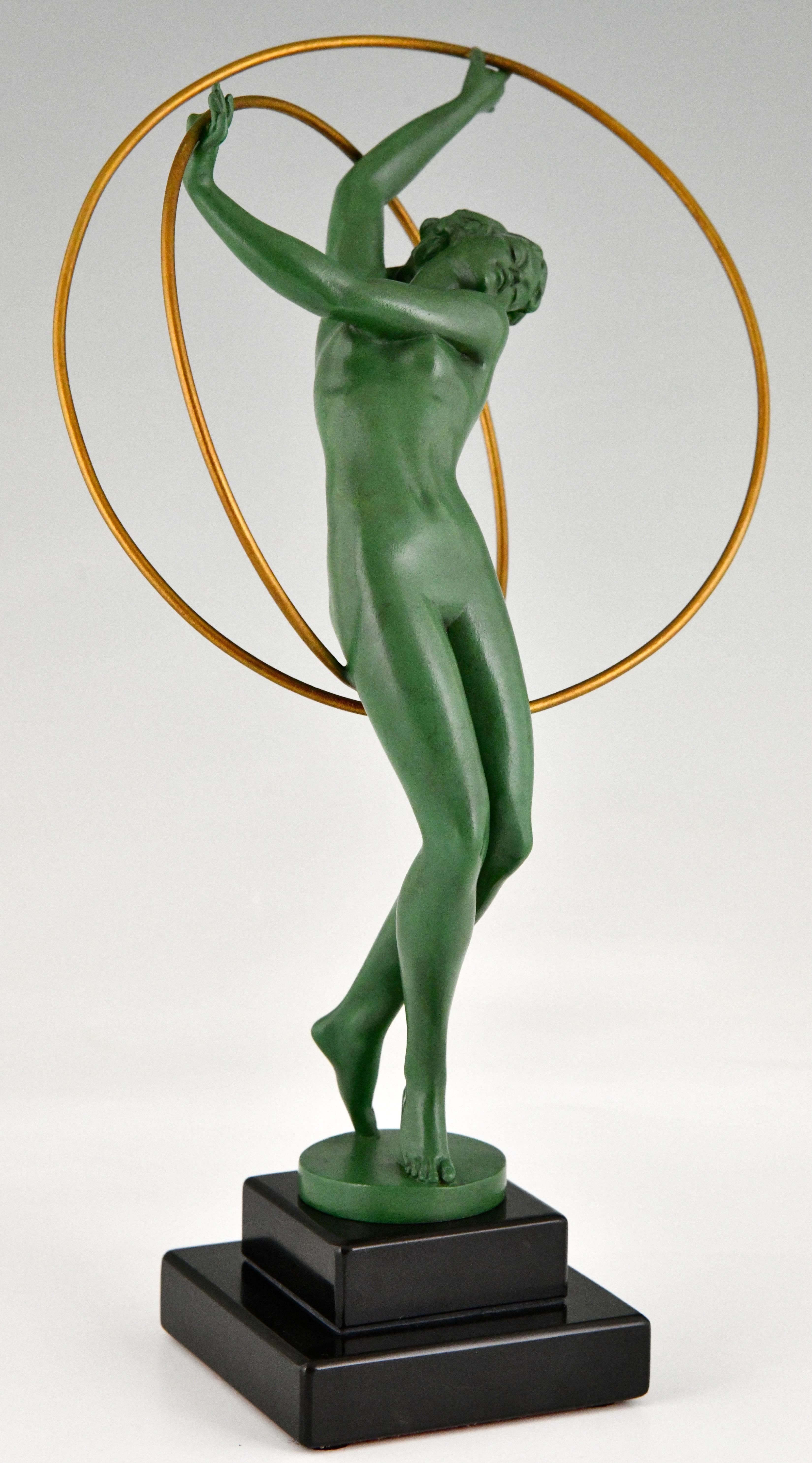 Art Deco sculpture nude hoop dancer signed by Fayral, pseudonym of Pierre Le Faguays.
Patinated Art Metal on Belgian Black marble base. 
France 1930.