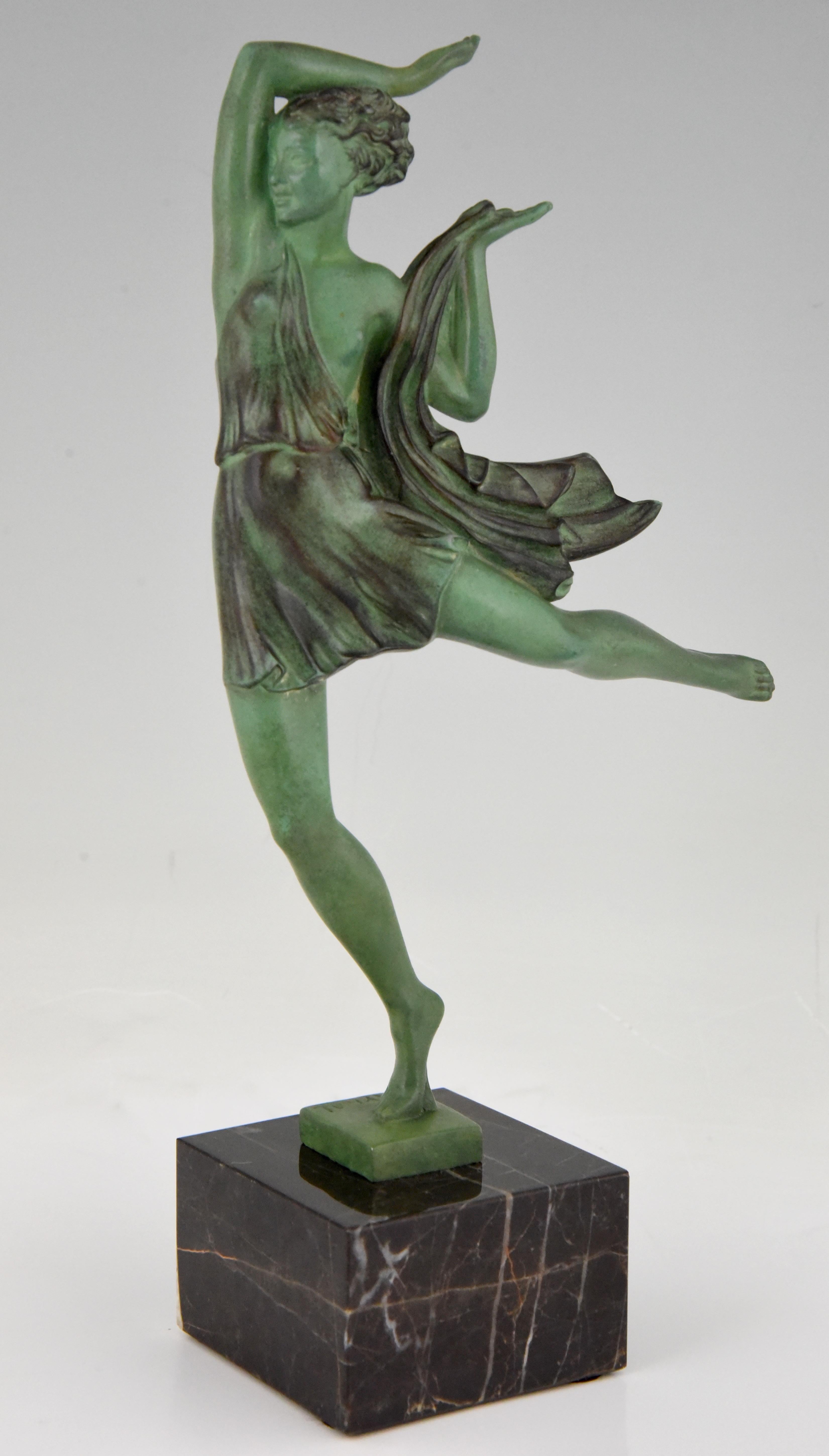 Art Deco sculpture of a dancing woman in an elegant pose. The figurine is signed Fayral, the pseudonym of Pierre Le Faguays and has a lovely green patina with shades. The dancer is mounted on a Belgian black base, France,