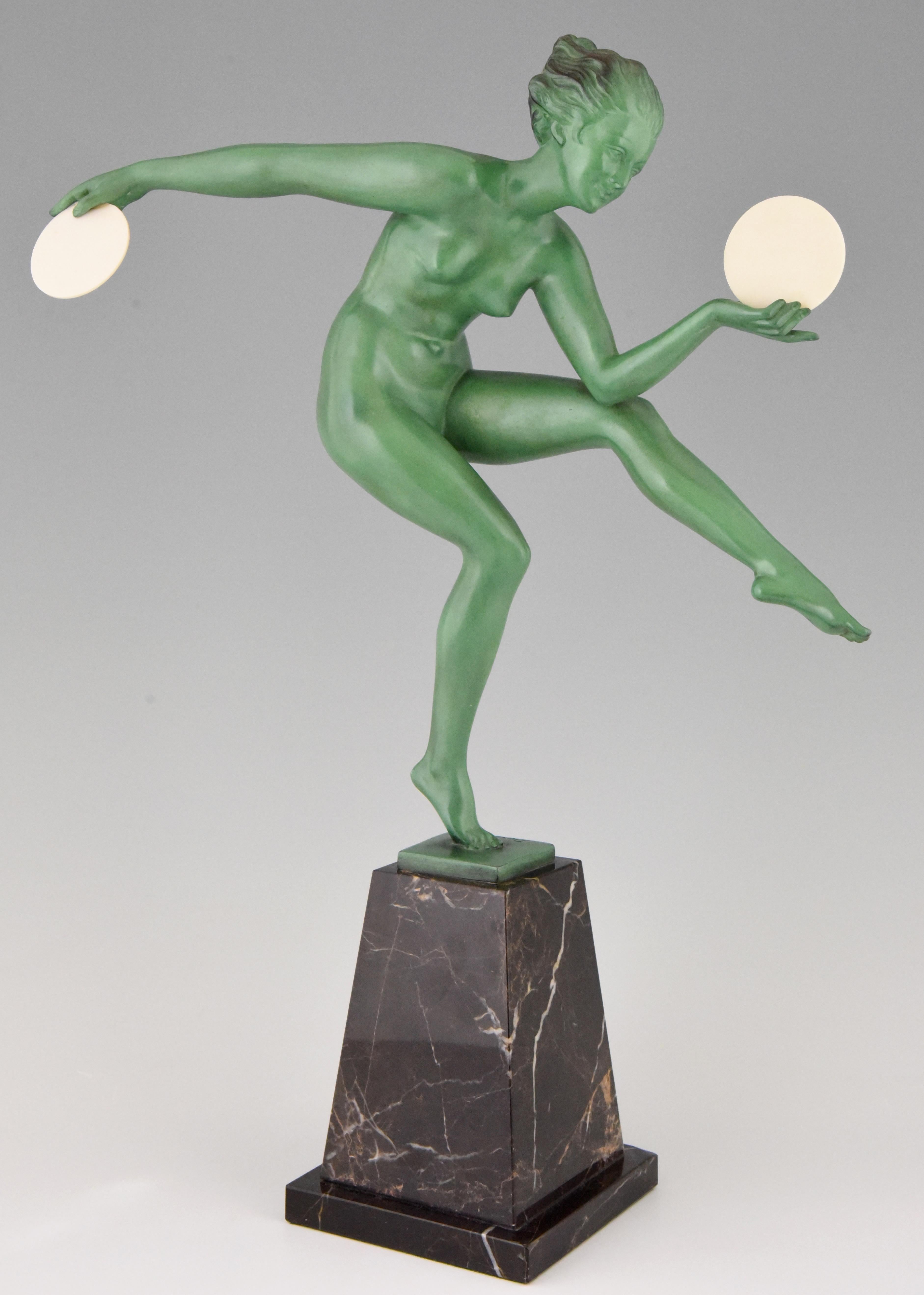 Impressive Art Deco sculpture of a nude dancer with discs, 19.5 inch tall by Derenne. Pseudonym used by Marcel Bouraine for his art metal sculptures cast by the Max Le Verrier foundry. Lovely original green patina, mounted on a marble base, France,