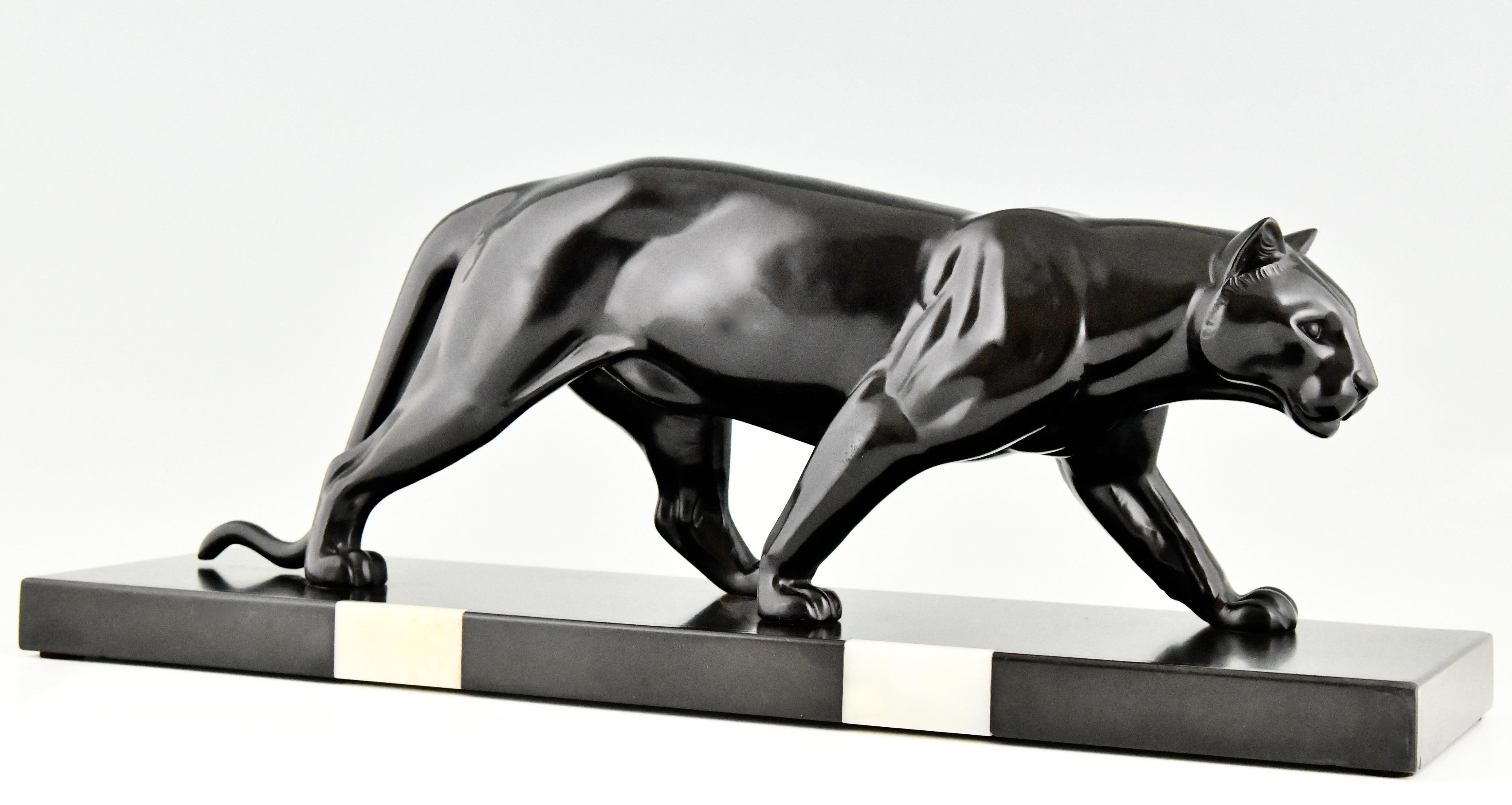 Art Deco sculpture of a panther by the French sculptor M. Leducq. Patinated Art metal. Marble base with onyx inlay. France 1930.