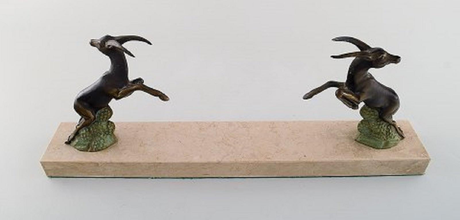 Mid-20th Century Art Deco Sculpture of Jumping Bucks in Patinated Metal on Marble Base, 1930s For Sale