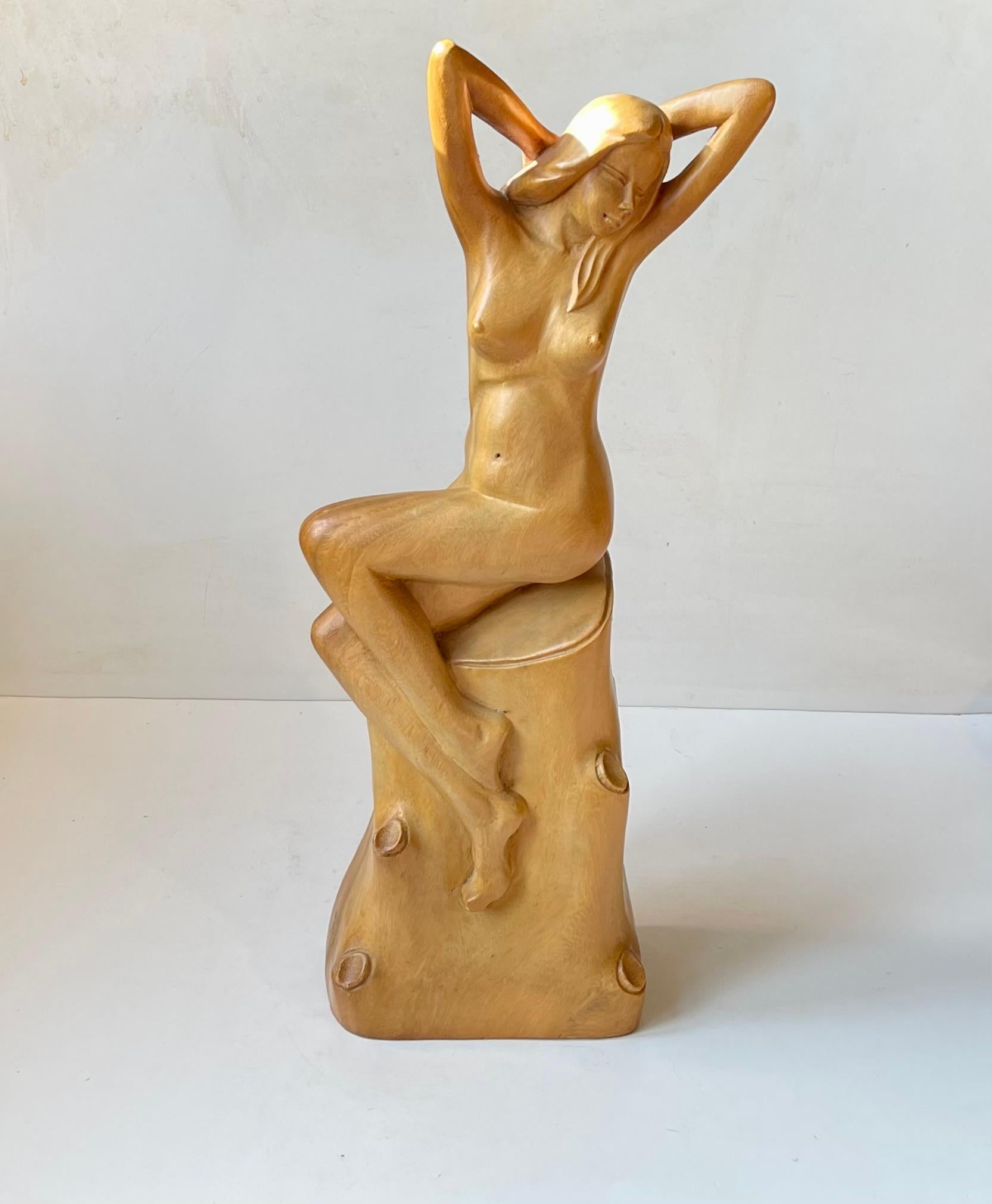 Exceptionally well-made hand carved/turned sculpture of nude your female. Its made from either birch or maple and from one piece. The alluring female posses naturally and is resting on a delicately carved tree stump. This piece does not have any