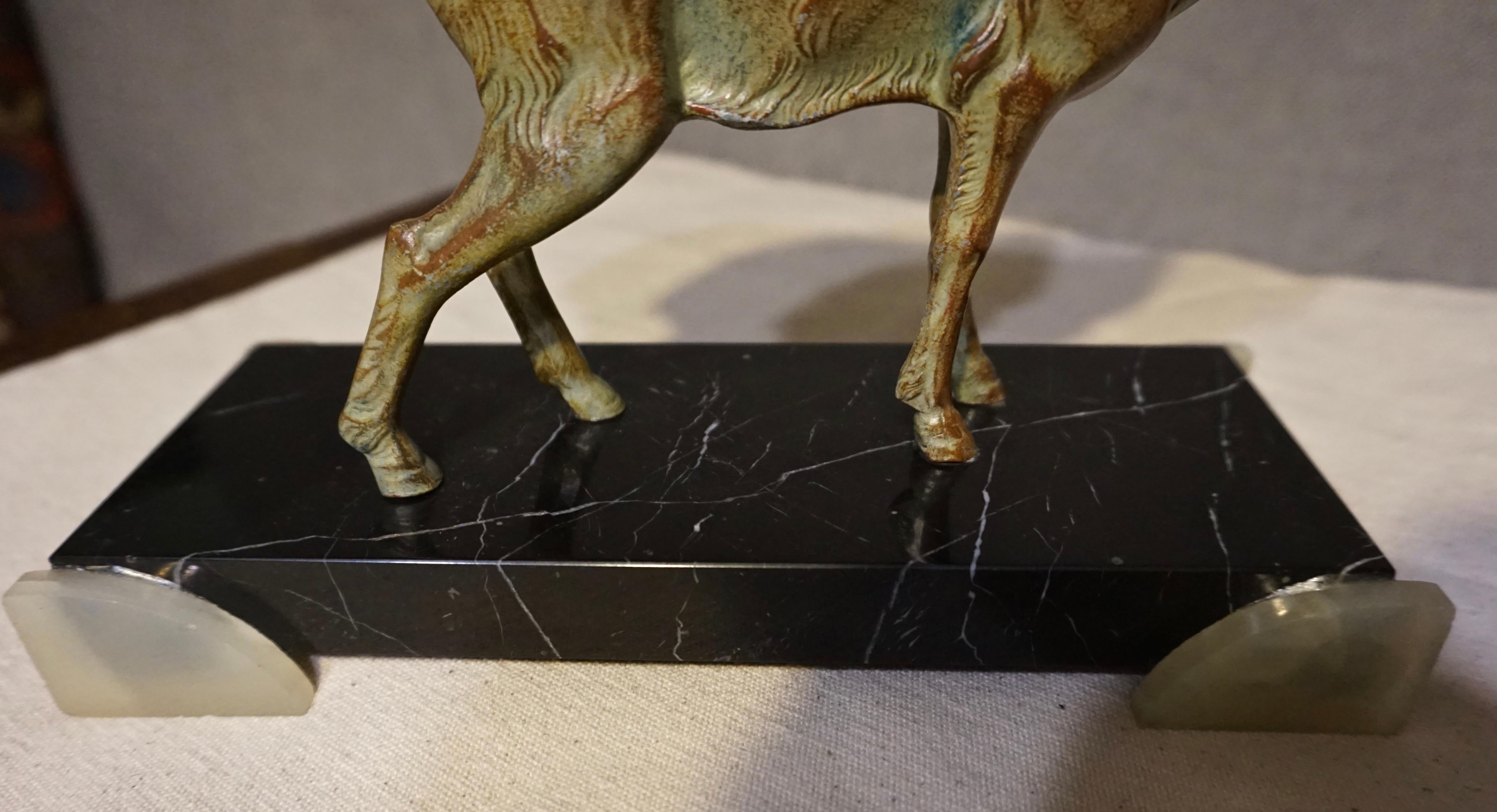 Beautifully expressed sculpture of a pronghorn antelope in a stationary gaze. Bolted to marble base and with incredible hand painted detail to imitate a bronzed look,

circa 1935.