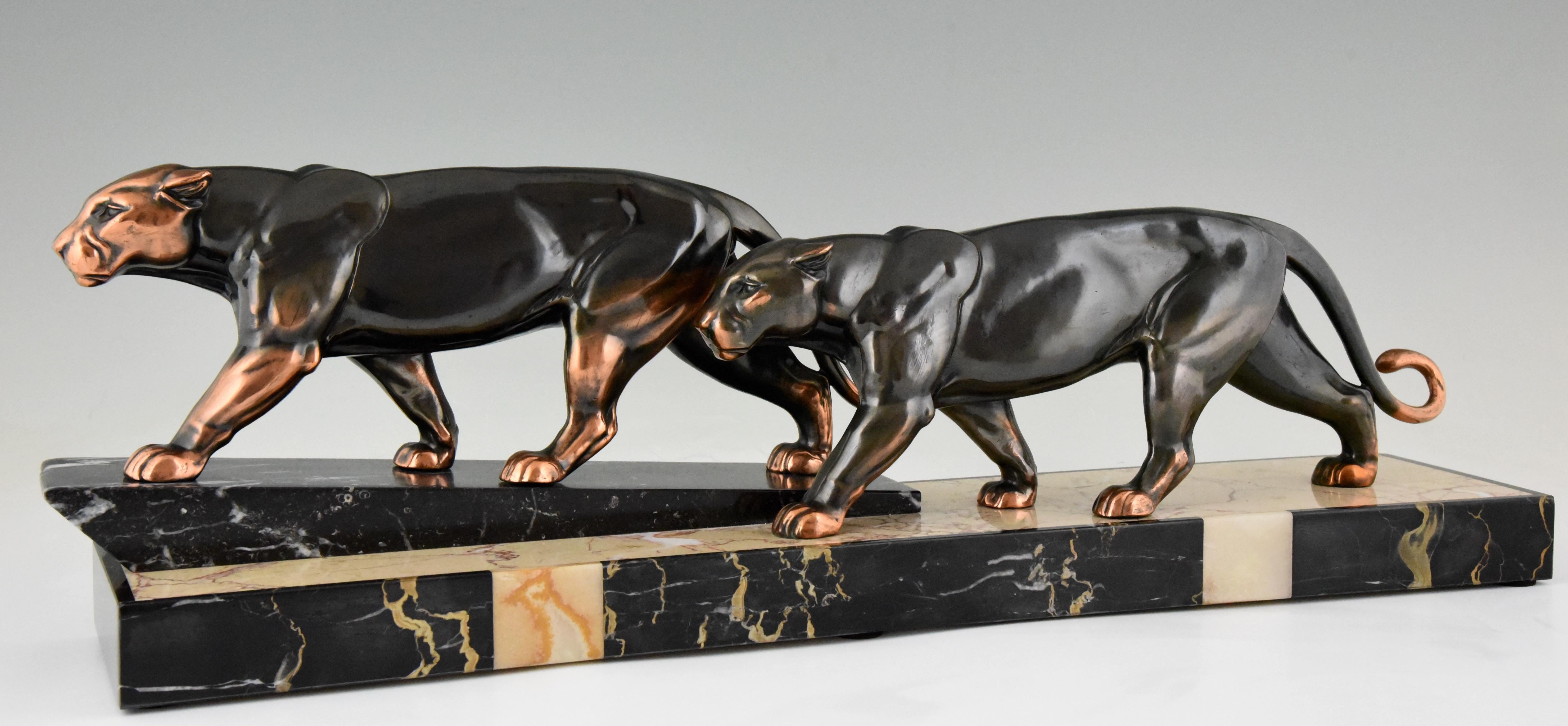 Art Deco group of two walking panthers by the French artist Alexandre Ouline in patinated Art Metal on a multi-color marble base, circa 1930. 

“Animals in bronze” by Christopher Payne. Antique collectors club. ?“Dictionnaire des peintres,