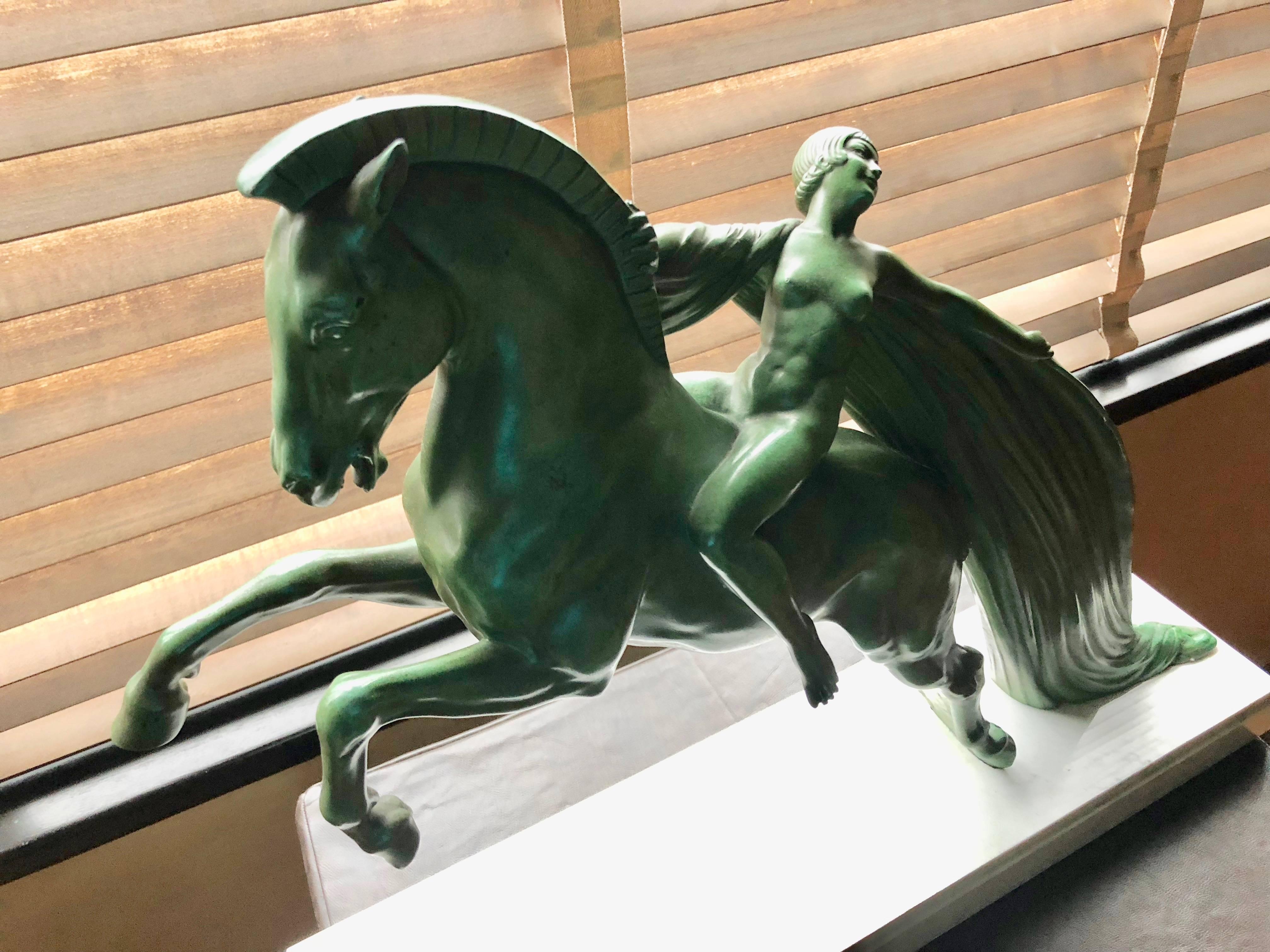 1930s Art Deco sculpture of a woman on a horse named Chevauchée signed by the artist, C. Charles. This original piece was made in the Max Le Verrier studio atelier in France. The sculpture was cast in bronzed metal and has a beautiful greenish