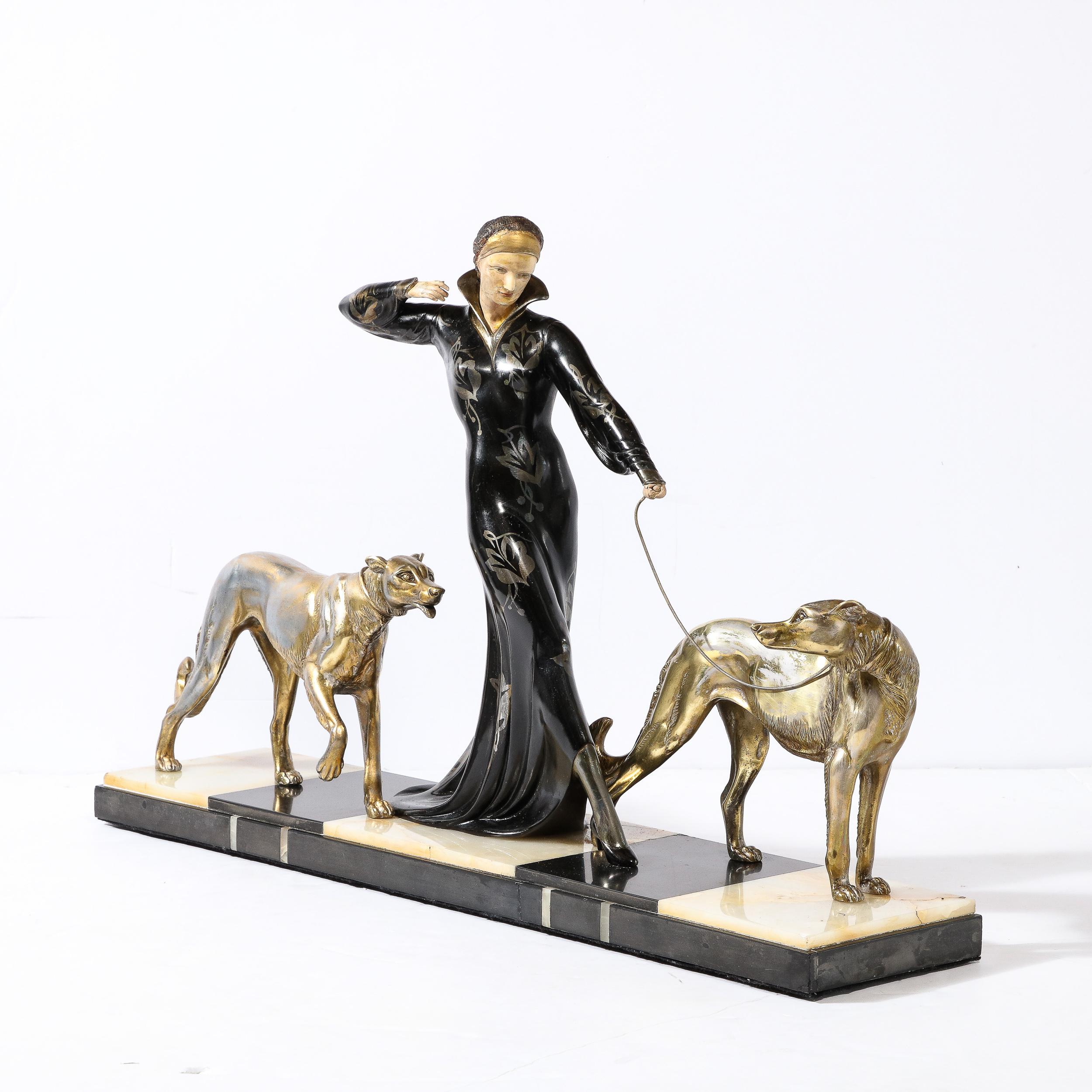 This materially stunning and elegant Art Deco Sculpture of a Woman Walking Borzois was created by the artist Georges Gori for the Company Etling in Paris France, Circa 1925 Features a tiered Black Marble and Onyx base,  with remarkably beautiful