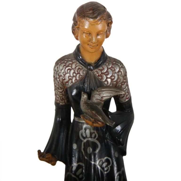 A Belgian Art Deco cast metal sculpture of a woman with two dogs, on a dark marble base, circa 1930.




  