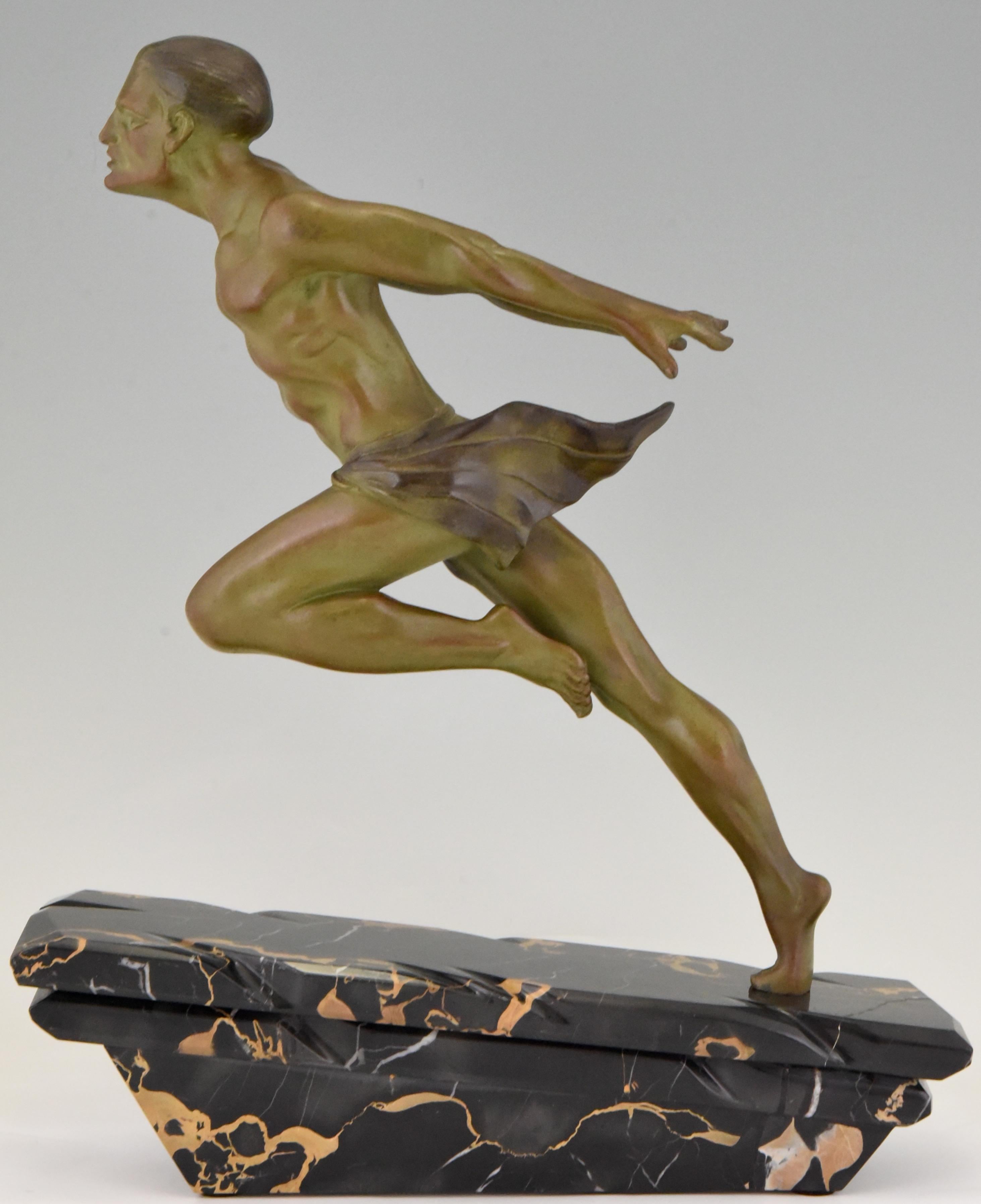 Art Deco sculpture of a running man or athlete signed by the sculptor L. Valderi, France, 1930. Patinated Art Metal on Portor marble base.
 