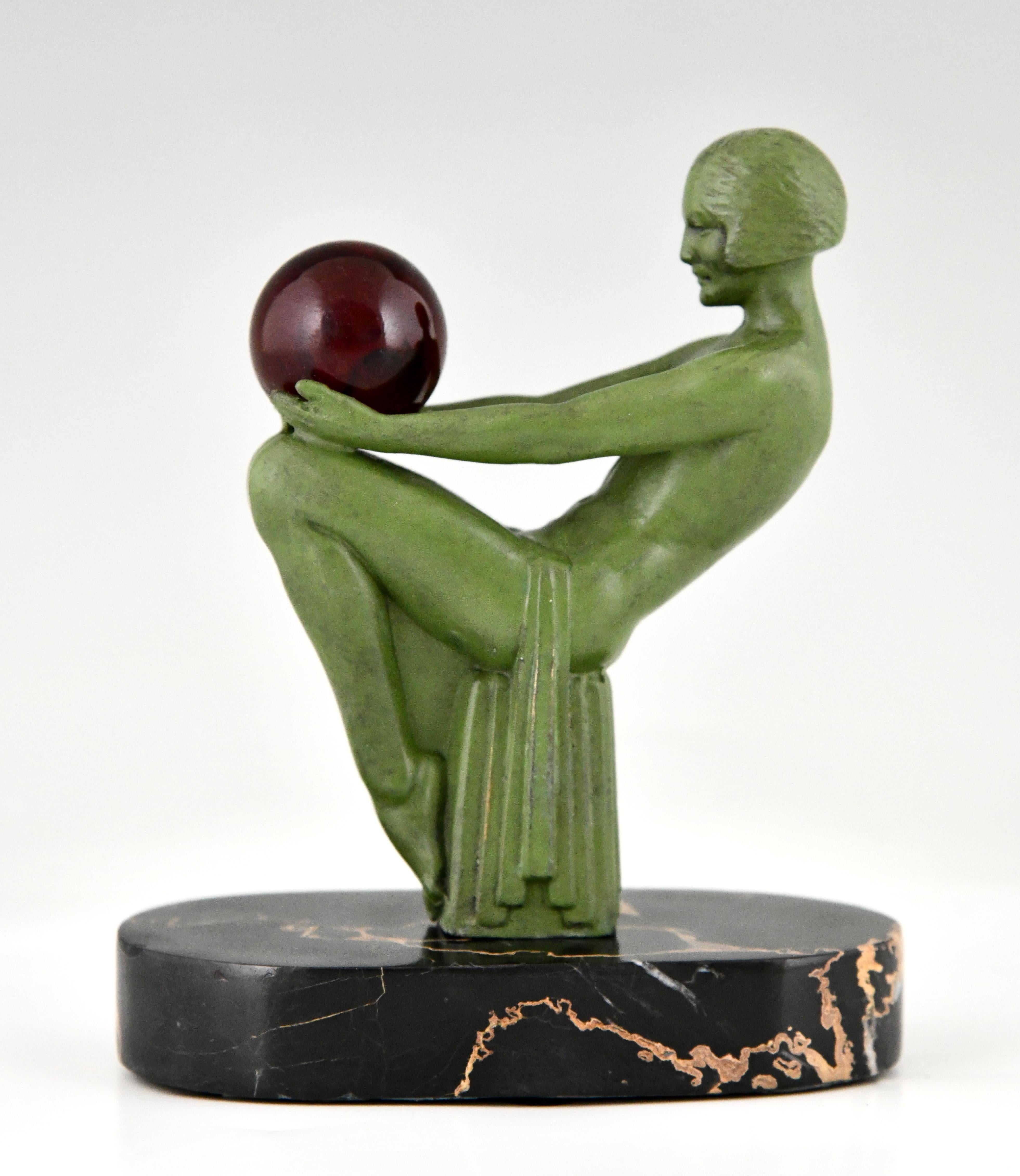 Art Deco sculpture seated nude with ball signed by Max Le Verrier. 
The sculpture is cast in Art Metal with green patina on an oval Portor marble base
France 1930.