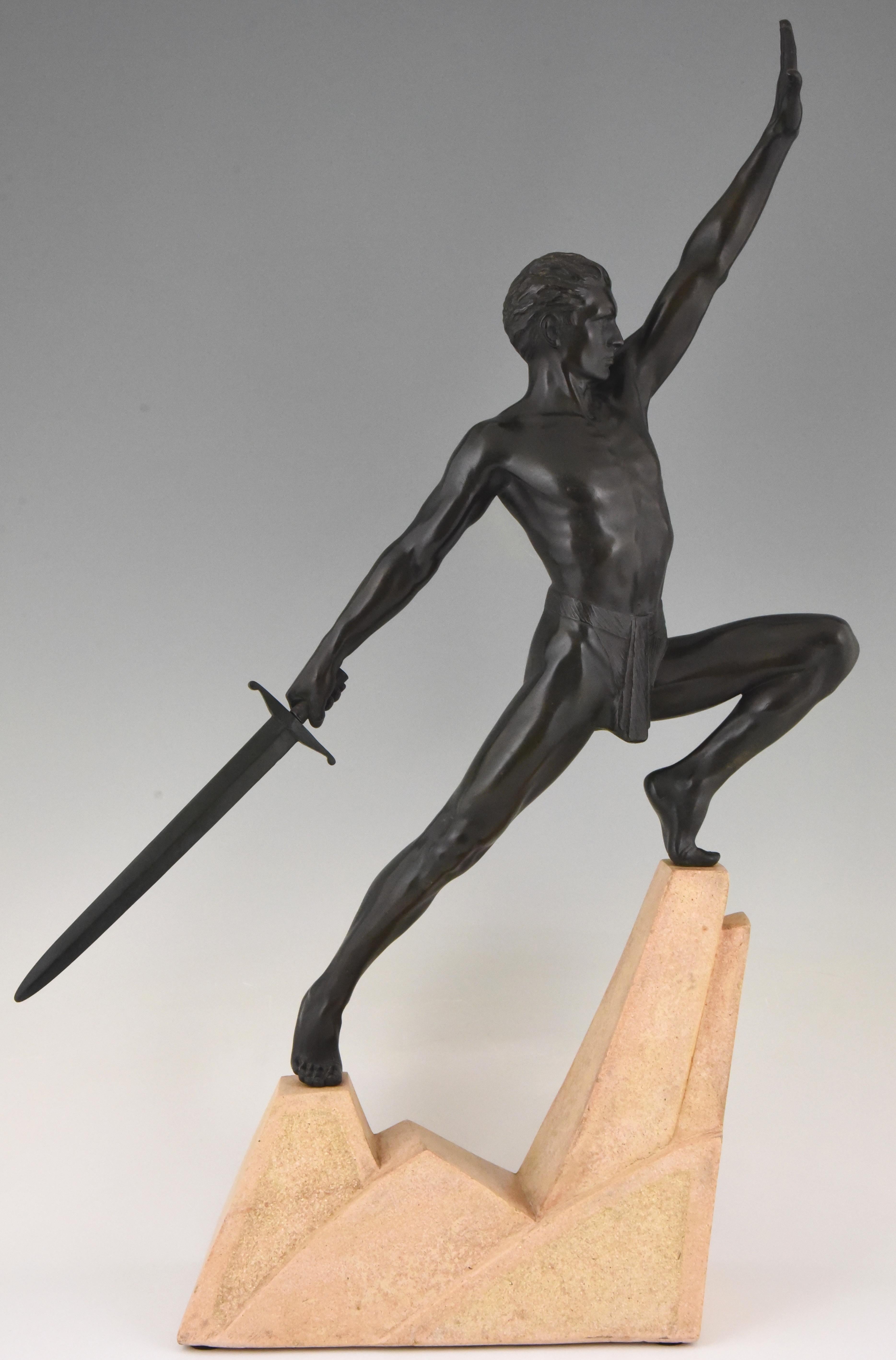 Powerful Art Deco sculpture of a man with sword standing on a rock, one arm outstretched. 