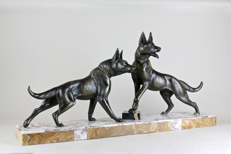 Large Art Deco sculpture out of France from circa 1925, depicting two observing shepherds. The fine worked metal cast sculpture was made with greatest attention to details and shows a nice patinated surface. The two dogs still stand on their