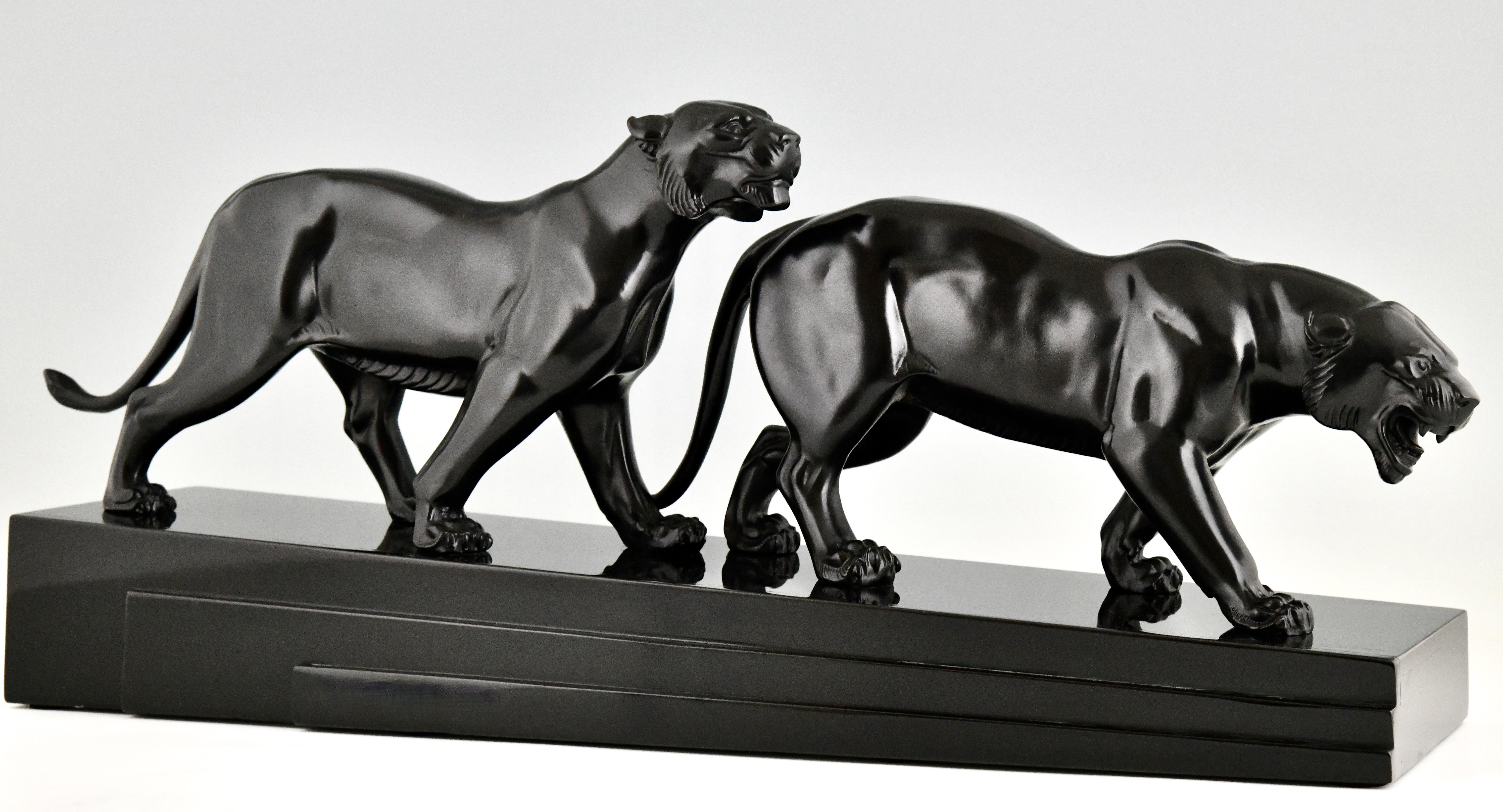 Art Deco sculpture two panthers signed by Irene Rochard. 
Patinated Art metal on a Belgian Black marble base. 
France 1930. 
Literature:
Art Deco sculpture two panthers signed by Irene Rochard. 
Patinated Art metal on a Belgian Black marble base.