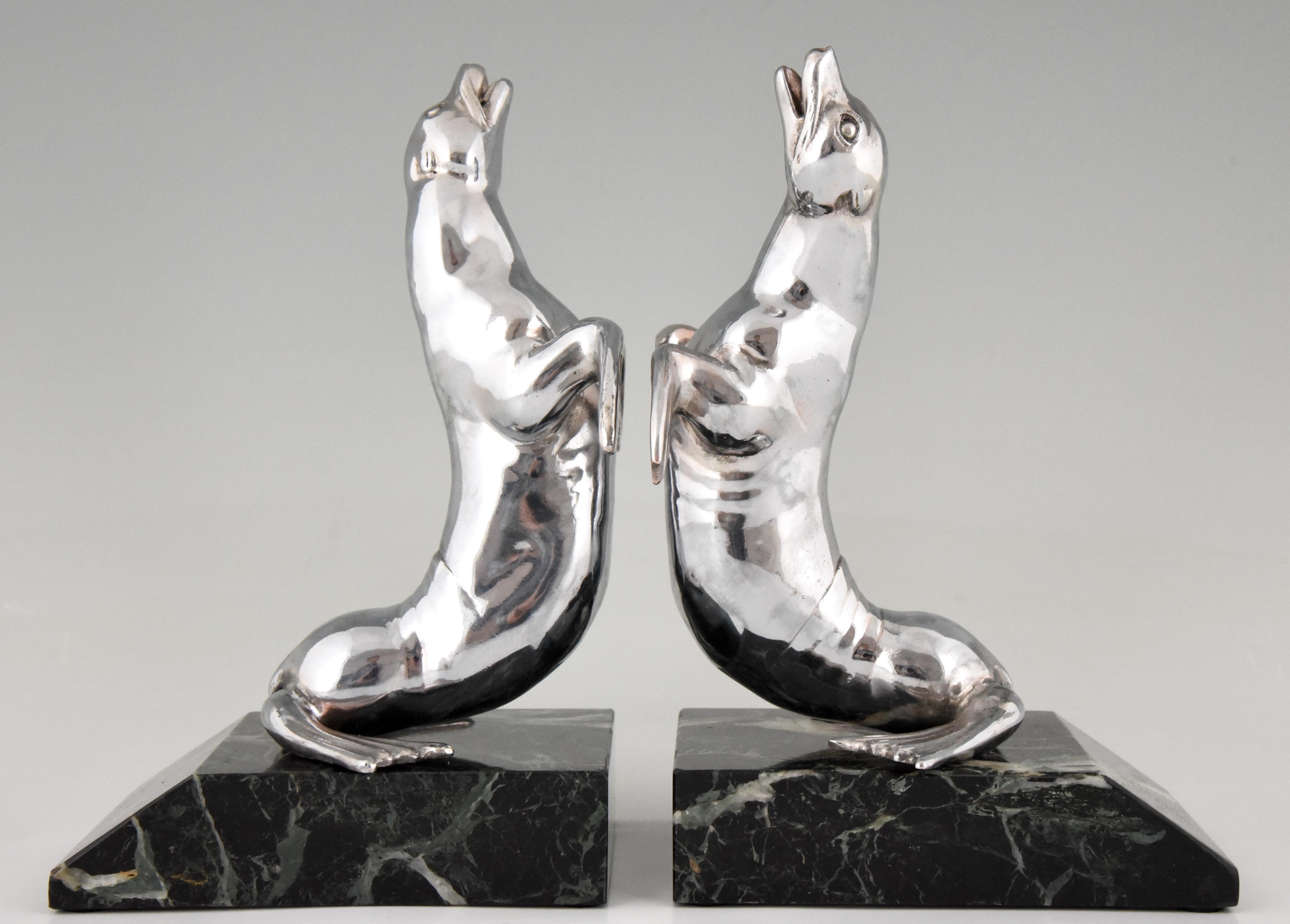 Nice pair of Art Deco seal bookends signed by the French artist Louis Albert Carvin, polished white metal on a green marble base, France, 1930. 
“Animals in bronze” by Christopher Payne. Antique collectors club.?
