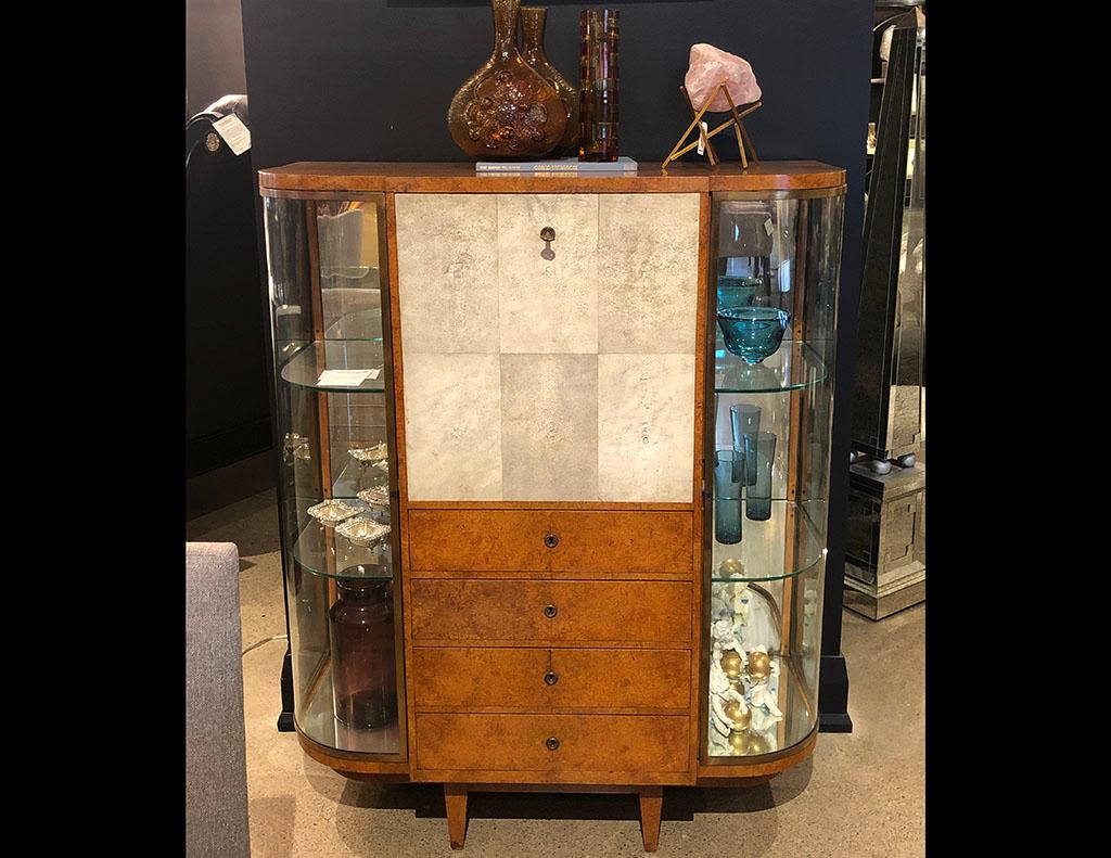 This Jules Deroubaix display cabinet secretaire is timeless, functional, and effortlessly chic. Made of burl sandalwood, it showcases a drop door paneled with gorgeous shagreen to add texture and French style. When opened, it reveals an ebony