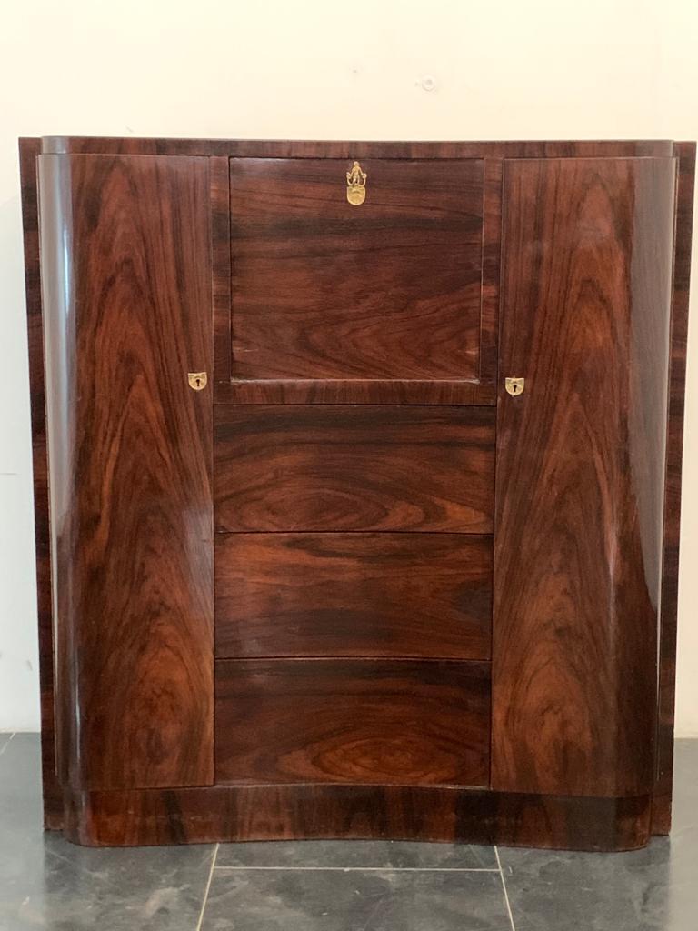 Art Deco Secretaire in feather mahogany.
Packaging with bubble wrap and cardboard boxes is included. If the wooden packaging is needed (crates or boxes) for US and International Shipping, it's required a separate cost (will be quoted separately).