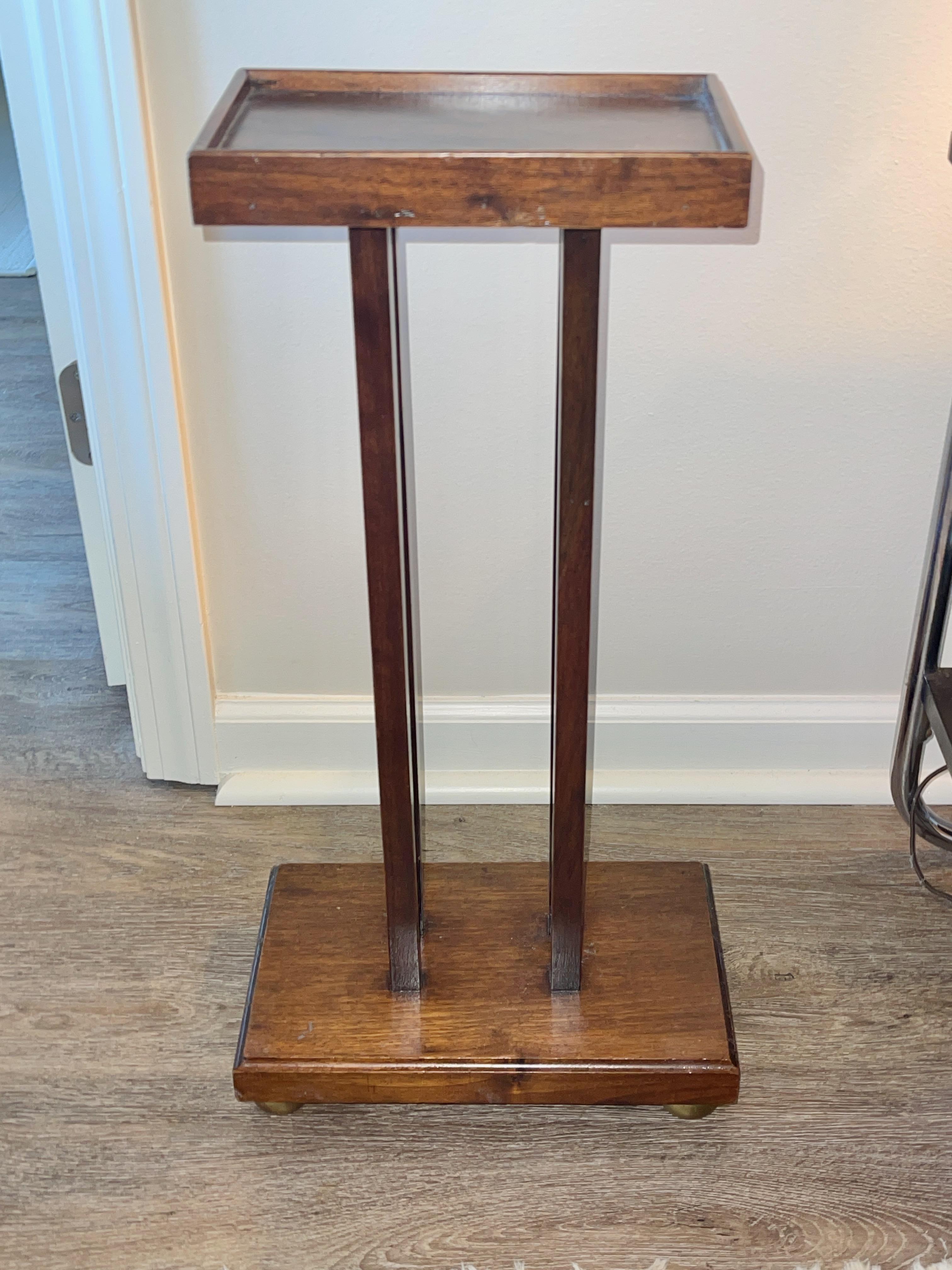 American Art Deco selette or individual drinks or smoking table. 
Wood pegs and dowels. 
Stands on four solid brass bun feet.
Overall dimensions: 24.5