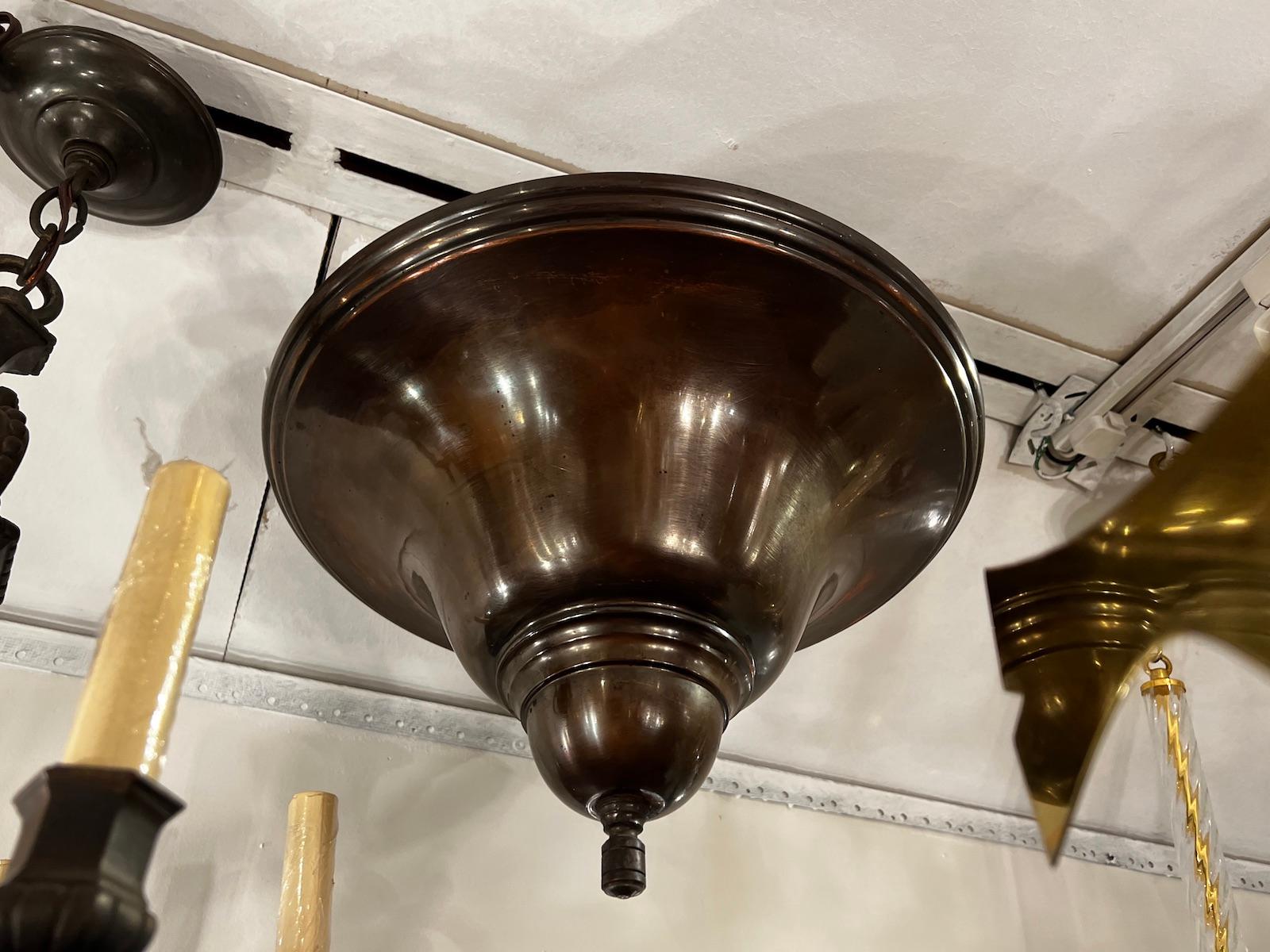 Antique 1920's English patinated bronze light fixture with 3 interior lights.

Measurements:
Minimum Drop: 14