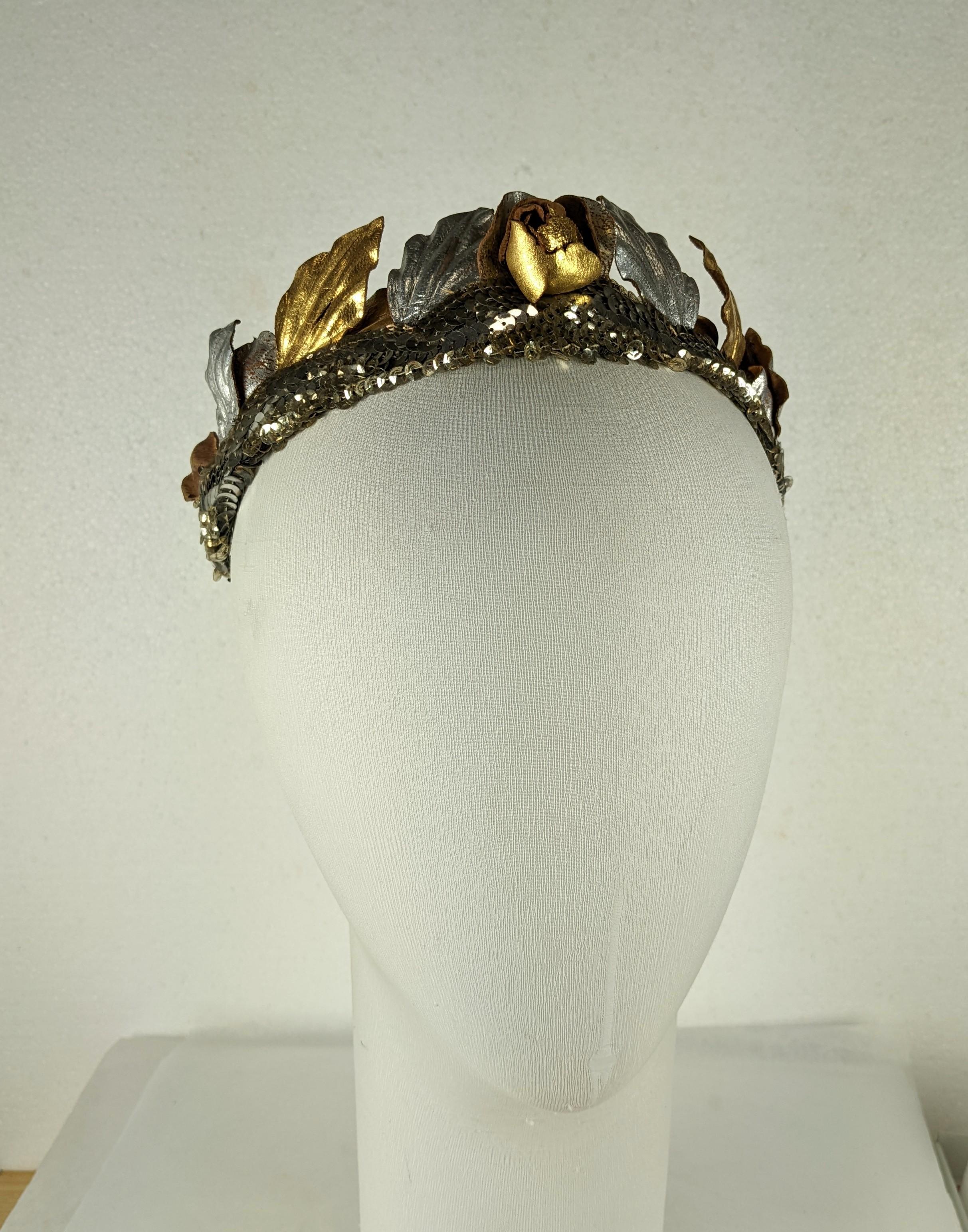 Wonderfl Art Deco Sequin Hair Bandeau of Gilt and Silver Leather Roses from the 1920's. Handmade Silver and Gold leaves and petals are mounted above a band of silver sequins. A Gilt leather rose sits at the center.  1920's France. 
Total 19