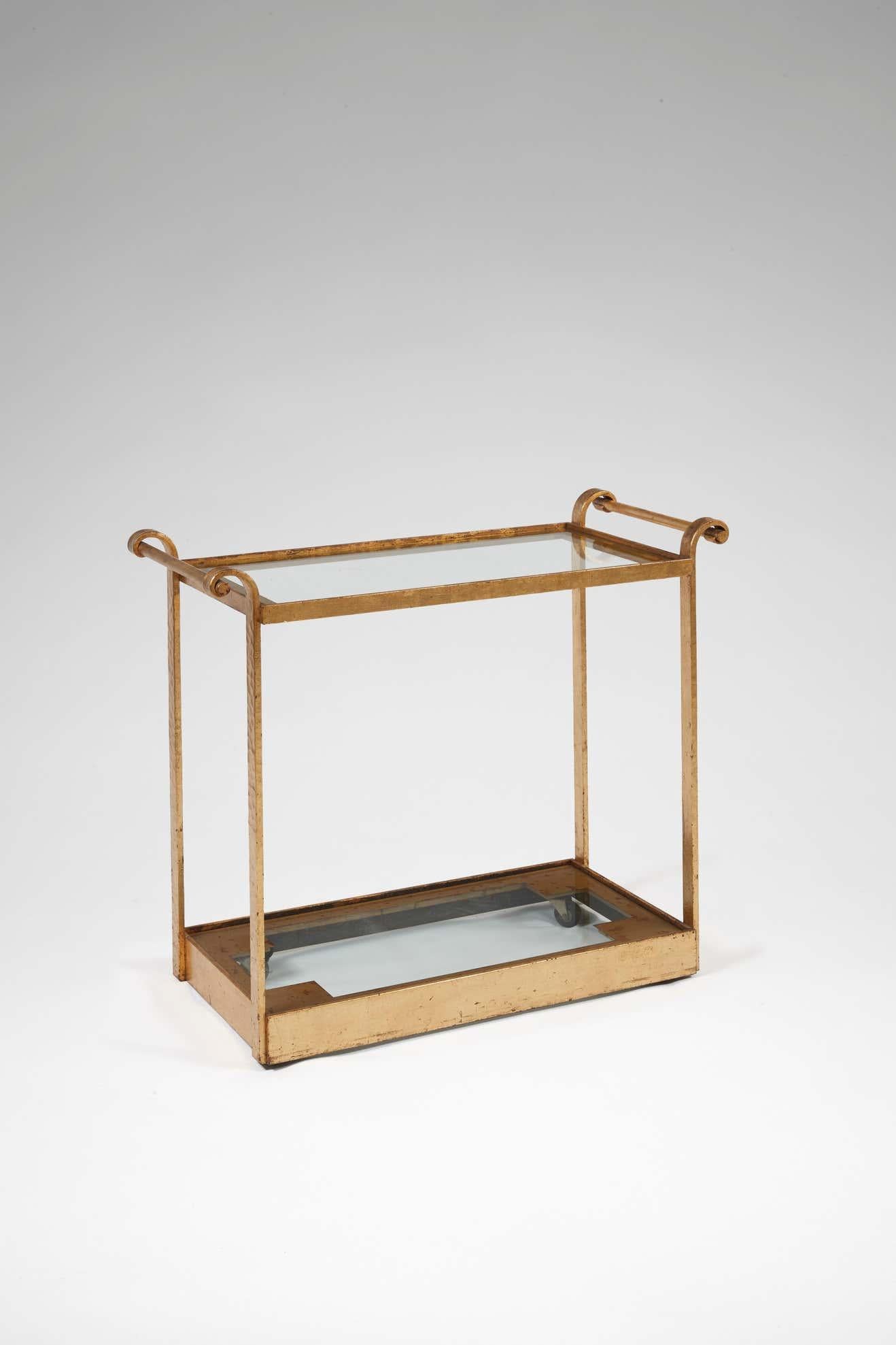 Serving trolley/bar cart by Michel Zadounaïsky in gilded wrought iron, with two rectangular glass shelves. 
Stamped.
   
