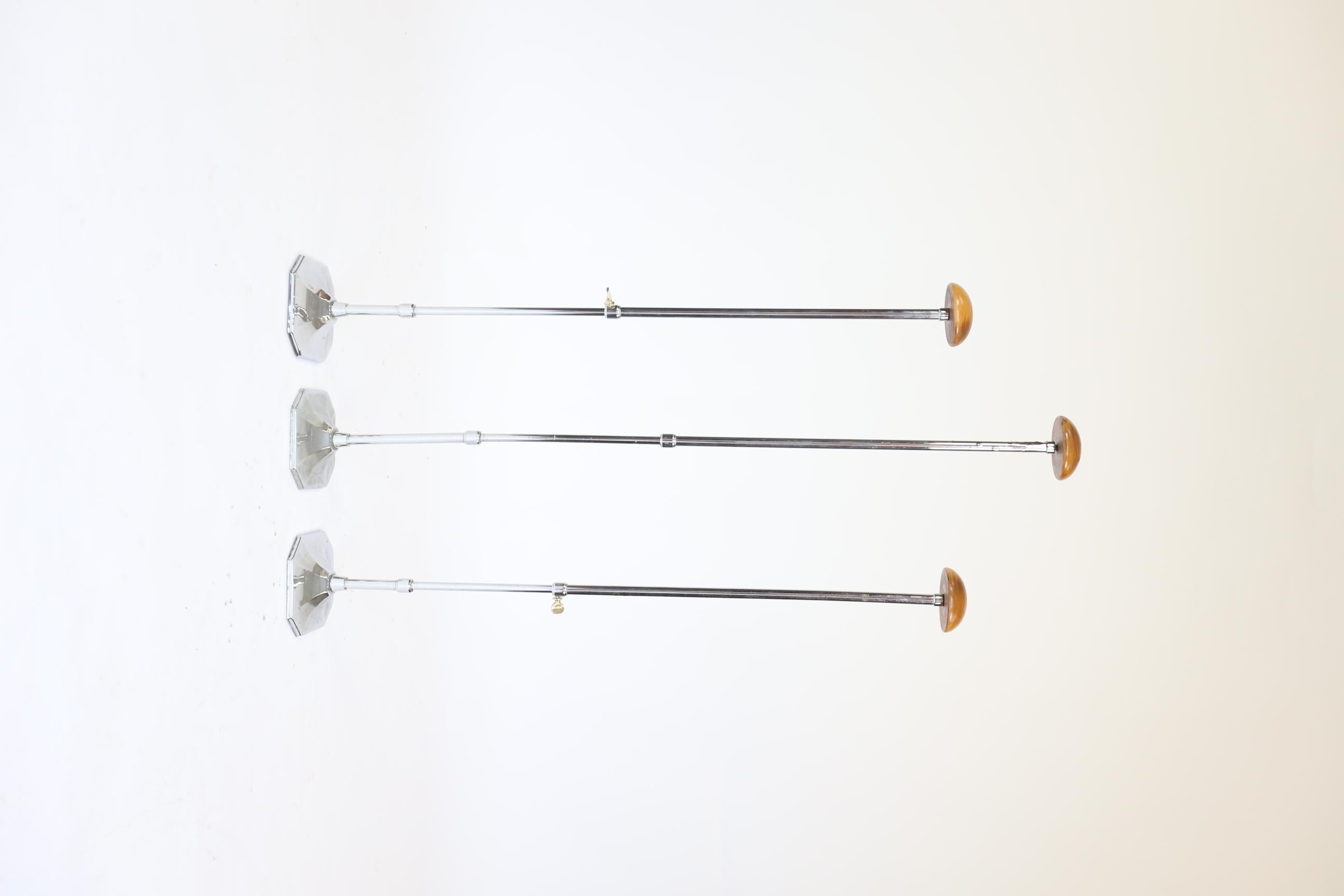 Art Deco Set 3 Chrome & Beech Shop Display Hat Stands
Telescopic Chrome plated Columns, 
With Brass Pinch Screw, 
Beech Dome tops to hold hats for Display
Art Deco Shaped Splayed Chrome caps sitting on cast Iron basis
Held by bolts underneath
Chrome