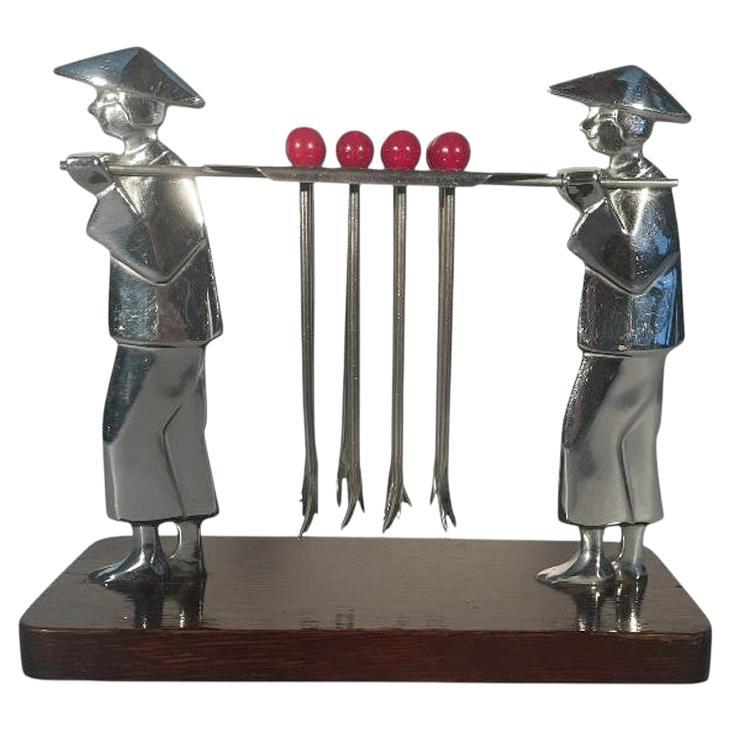 Art Deco Set of 12 Cocktail Picks Being Carried by Two Men Carrying a Litter