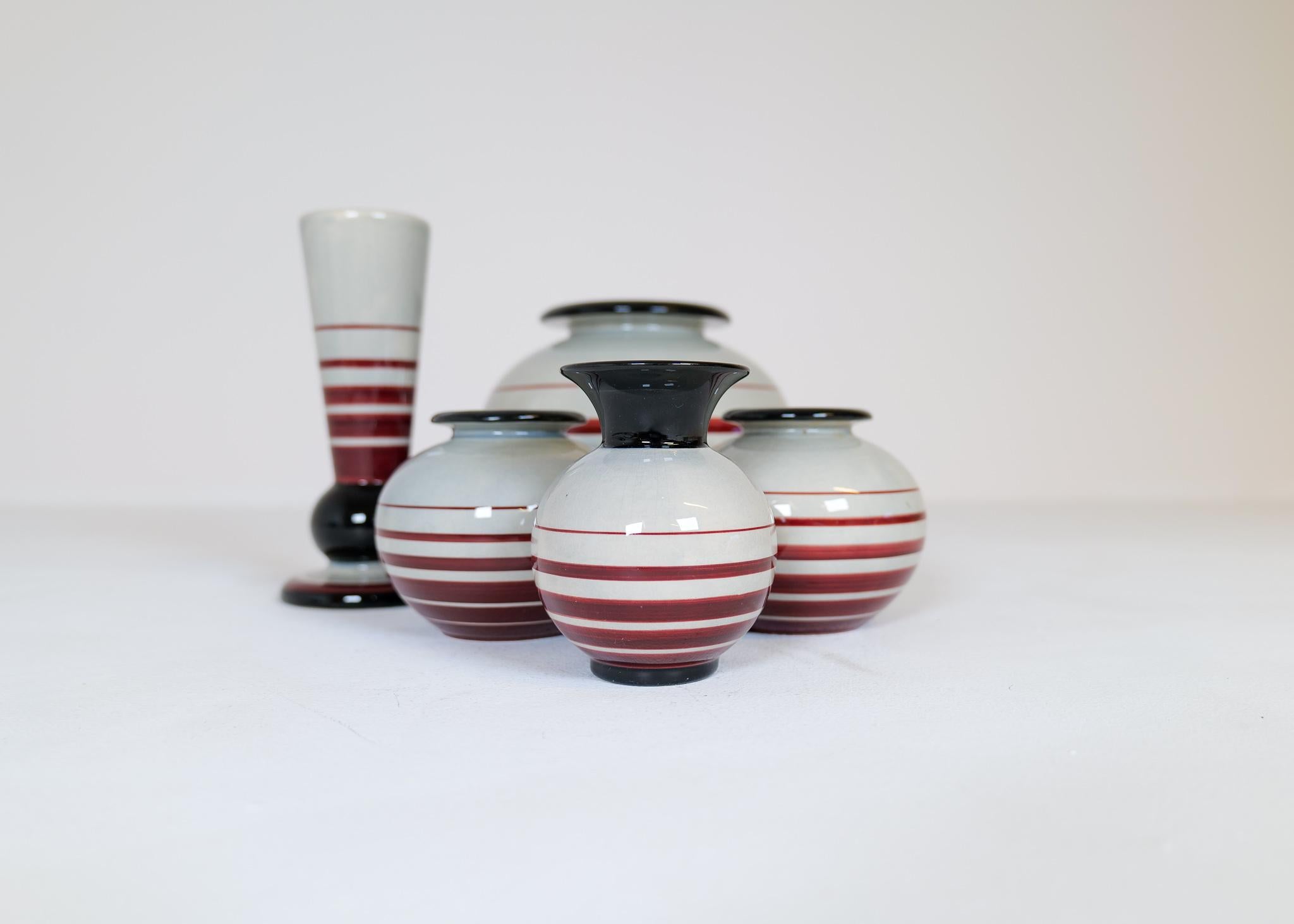 This set containing 5 Ceramic vases were produced during the 1940s in Sweden. The Art Deco pieces was designed by Ilse Claesson and made at Rörstrand. They are all handmade and hand painted. Typical to this era they are all formed with a rounded