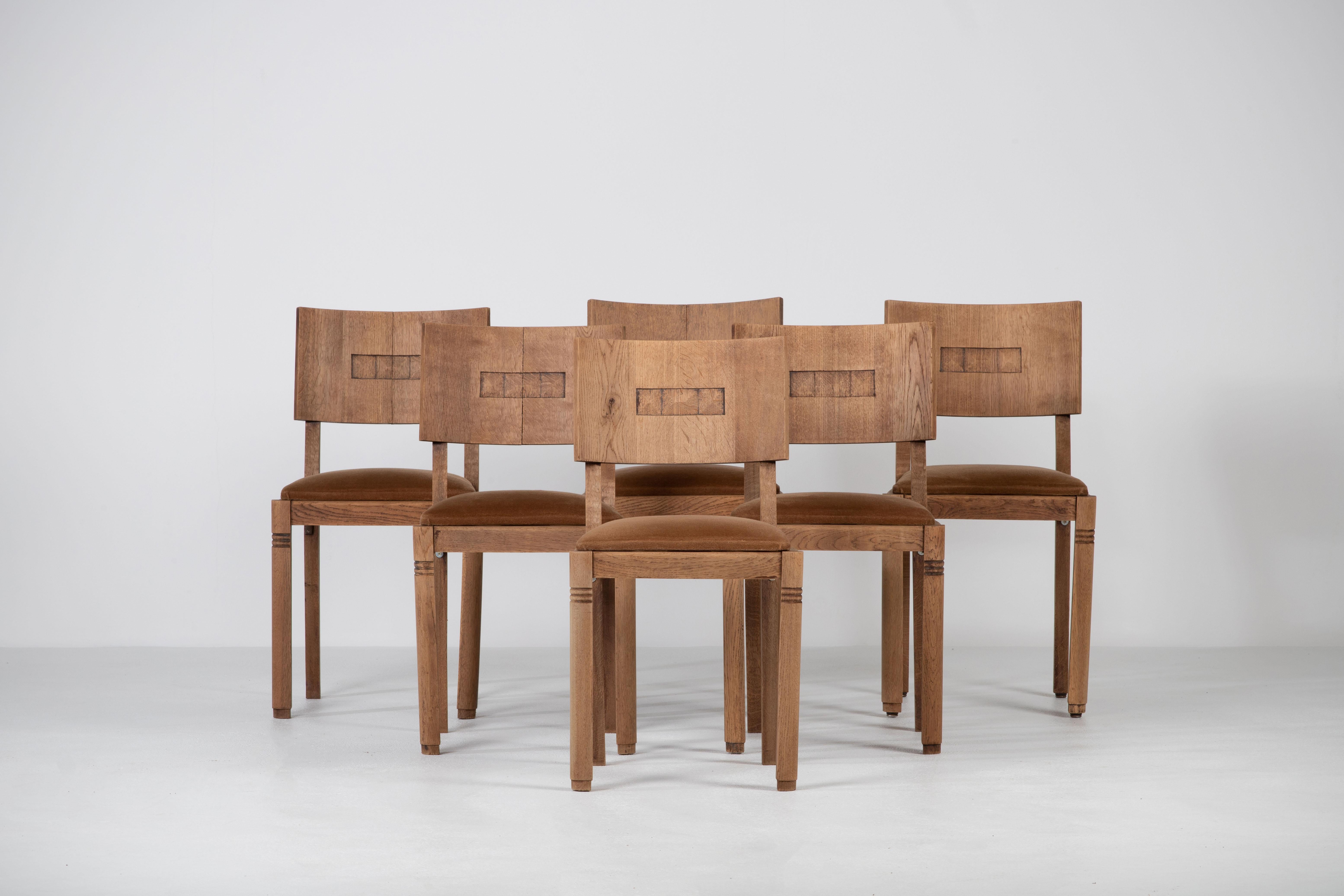 Cet ensemble de six chaises de salle à manger Art déco françaises en chêne massif a été créé dans les années 1940 avec une inspiration de Charles Dudouyt.

On y voit clairement le travail de l'école française des années 1940. Les panneaux du