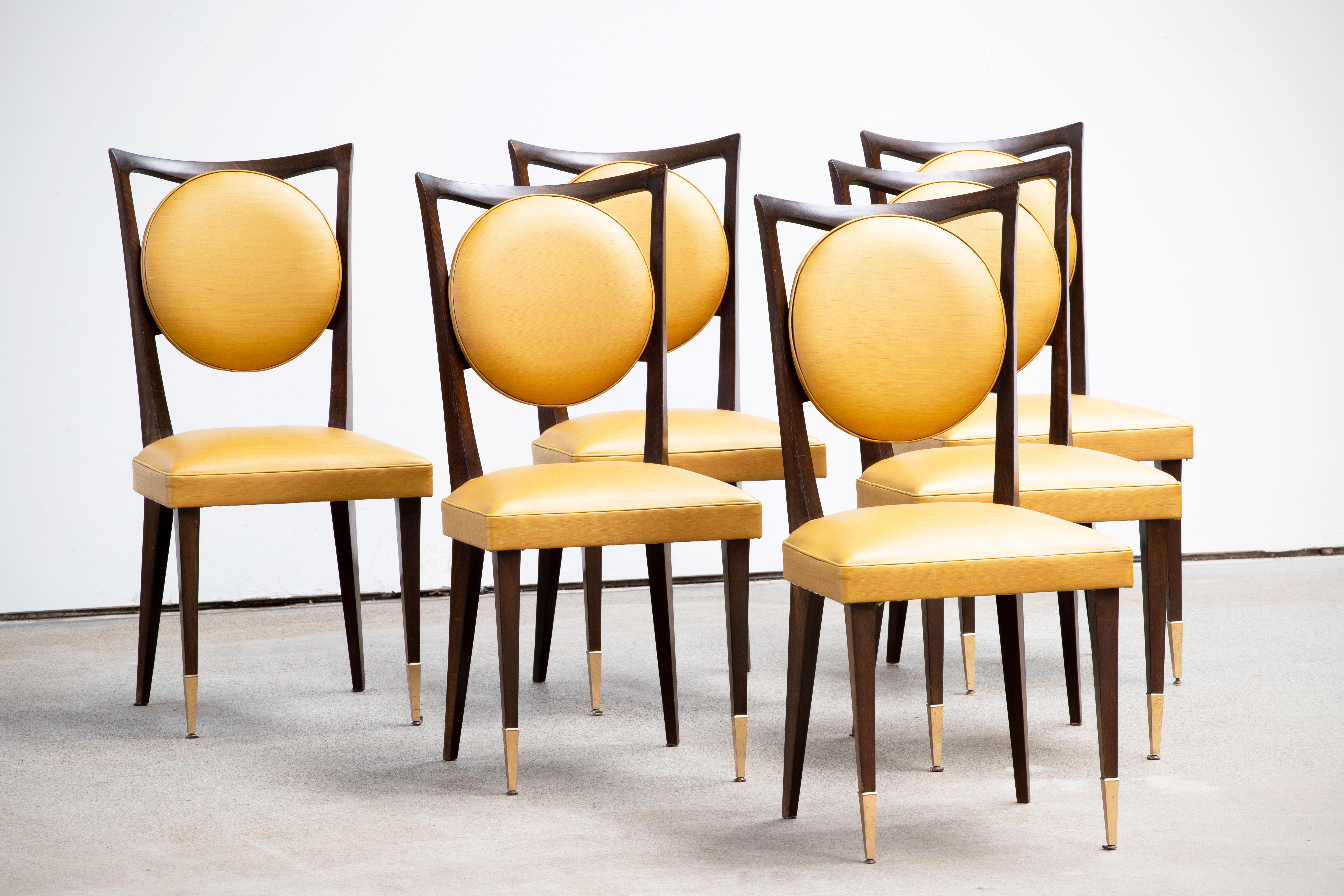Set of six upholstered high back chairs covered in yellow vynil, exhibiting traditional French design elements in a deep Oak finish. Restored and polished.