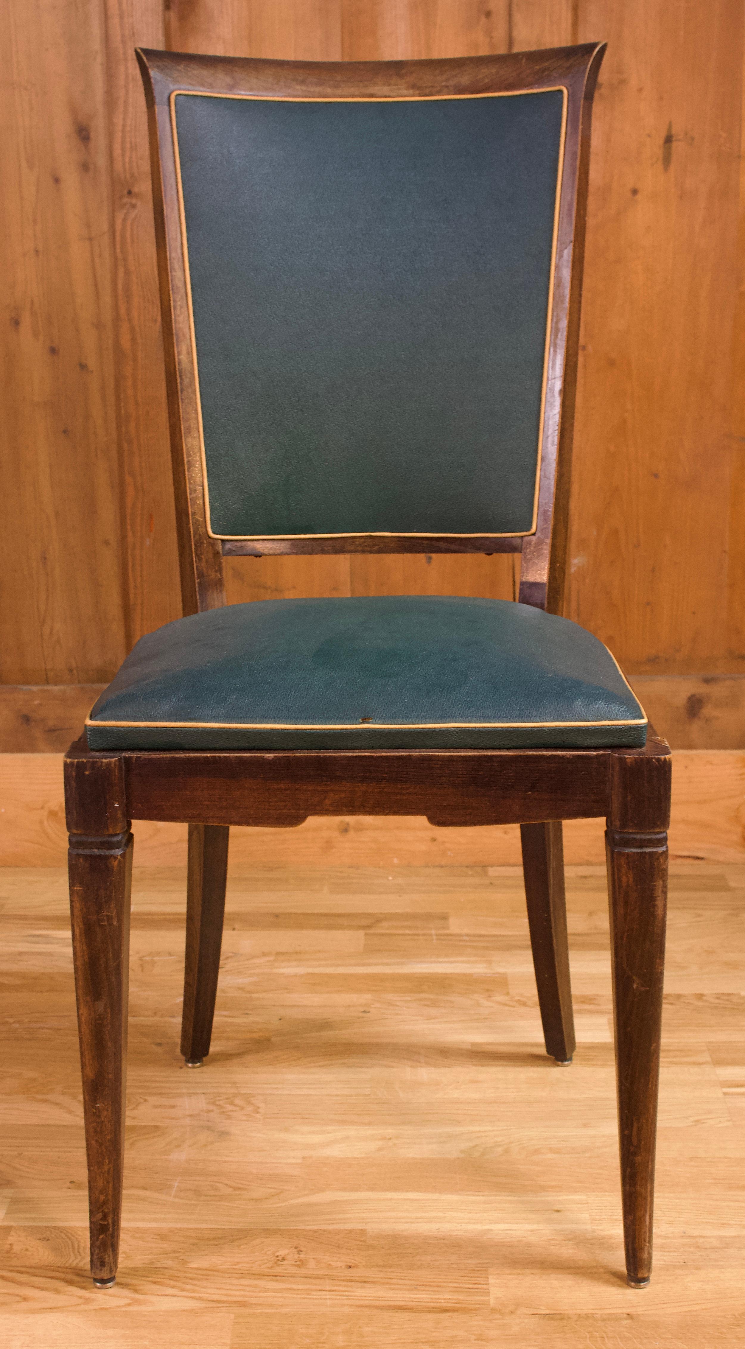 Very good quality living room set of foor art deco living room chairs with slightly curved front feet. The color of the faux leather is Jaguar green with a gold trim. The back is slightly arched.

Circa 1950.
 