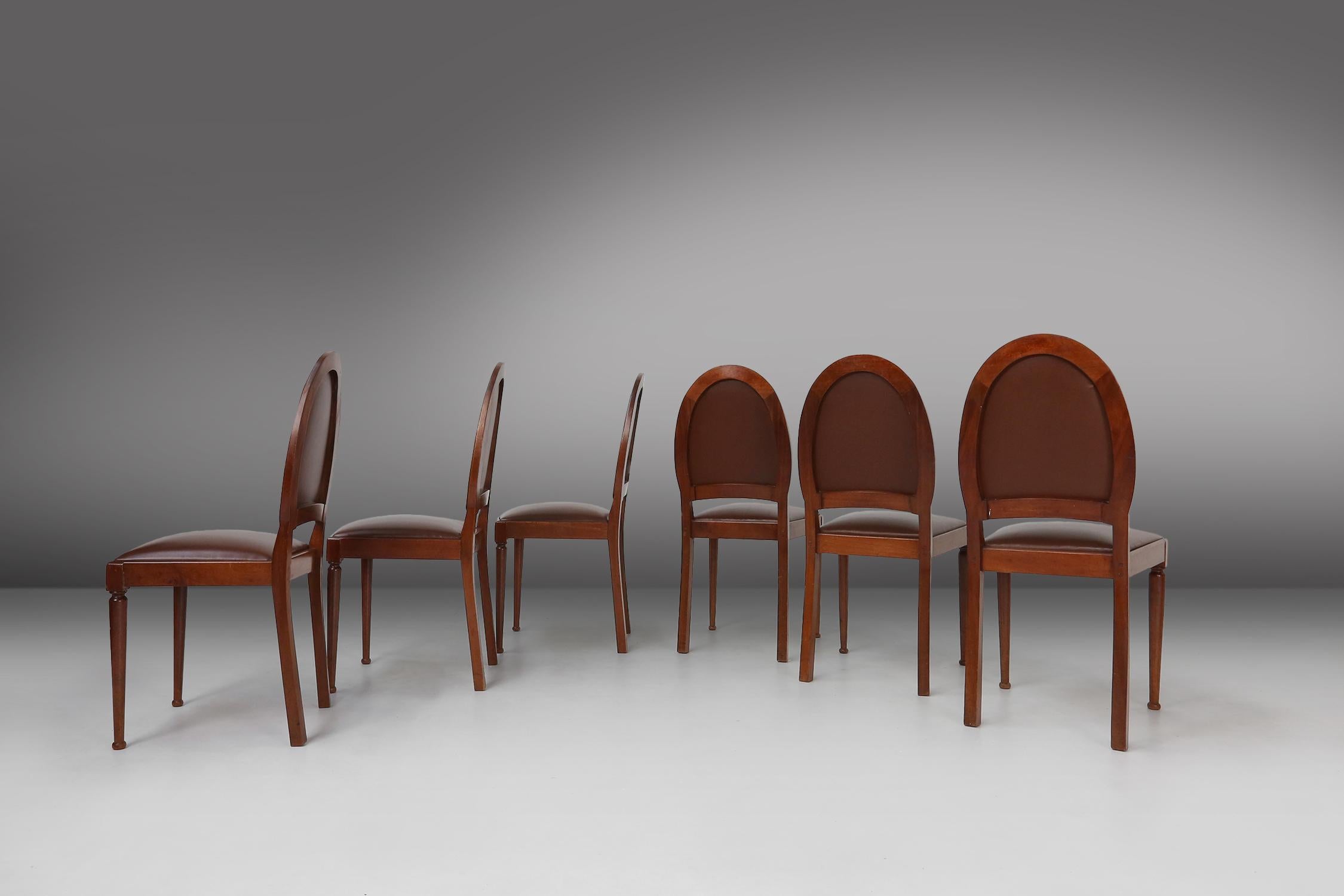 This set of six art deco chairs made by De Coene in Belgium in 1930. The chairs are made of full wood and have a brown leatherette seat. They have the typical art deco style, with a curved back and elegant lines. These chairs are a perfect example