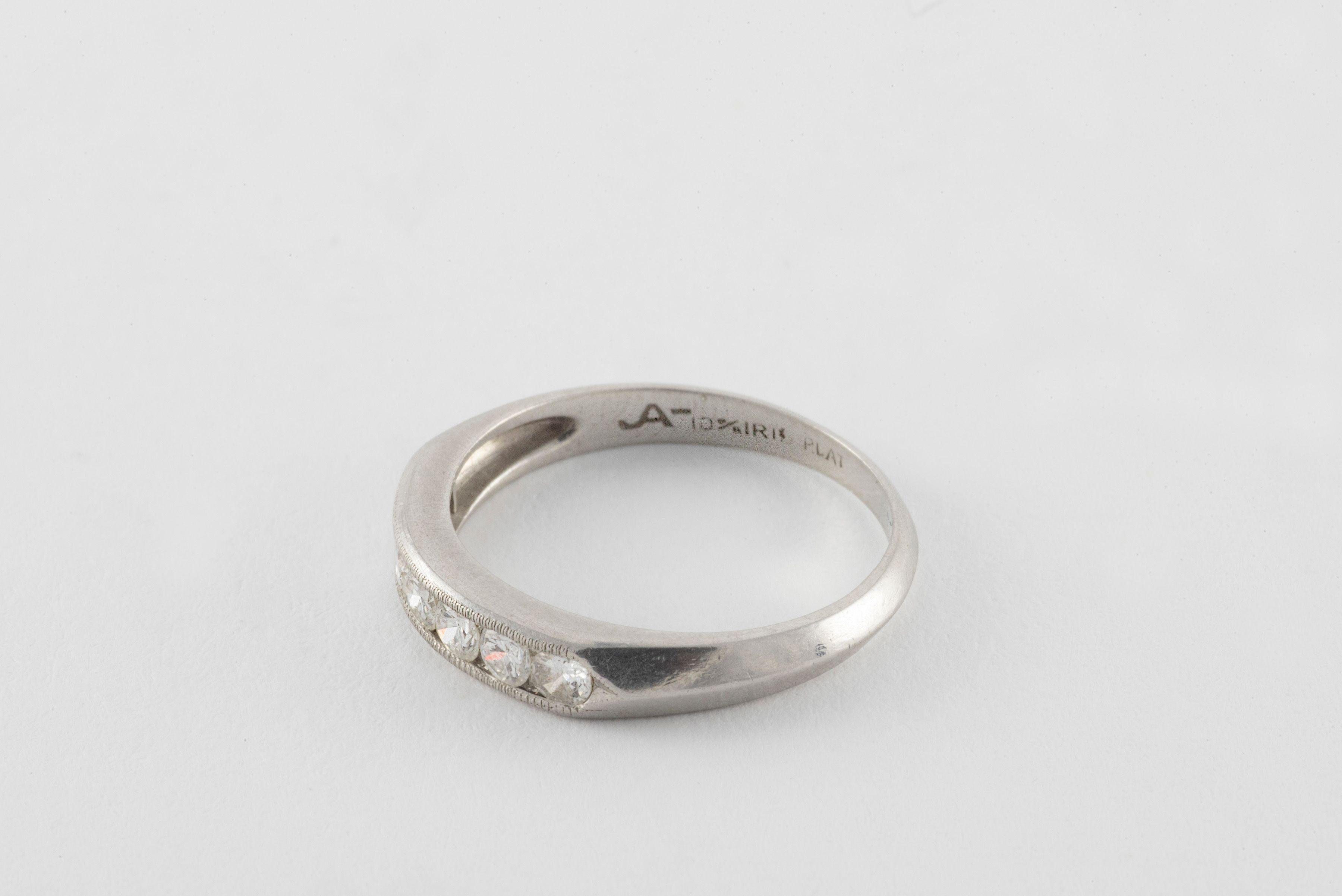 Seven sparkling Old European cut diamonds totaling approximately 0.35 carats, F color, VS clarity, bordered by delicate millegraining line the top of this antique wedding band fashioned from platinum. 