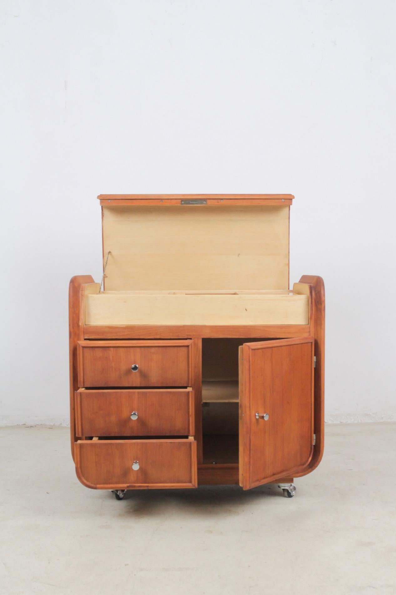 This restored Art Deco cabinet features a lot of little trays, hidden boxes, tiny drawers and shelves - this makes it perfect for storage tools for needlework, knitting, painting or a large collection of jewellery. It has got perfectly working