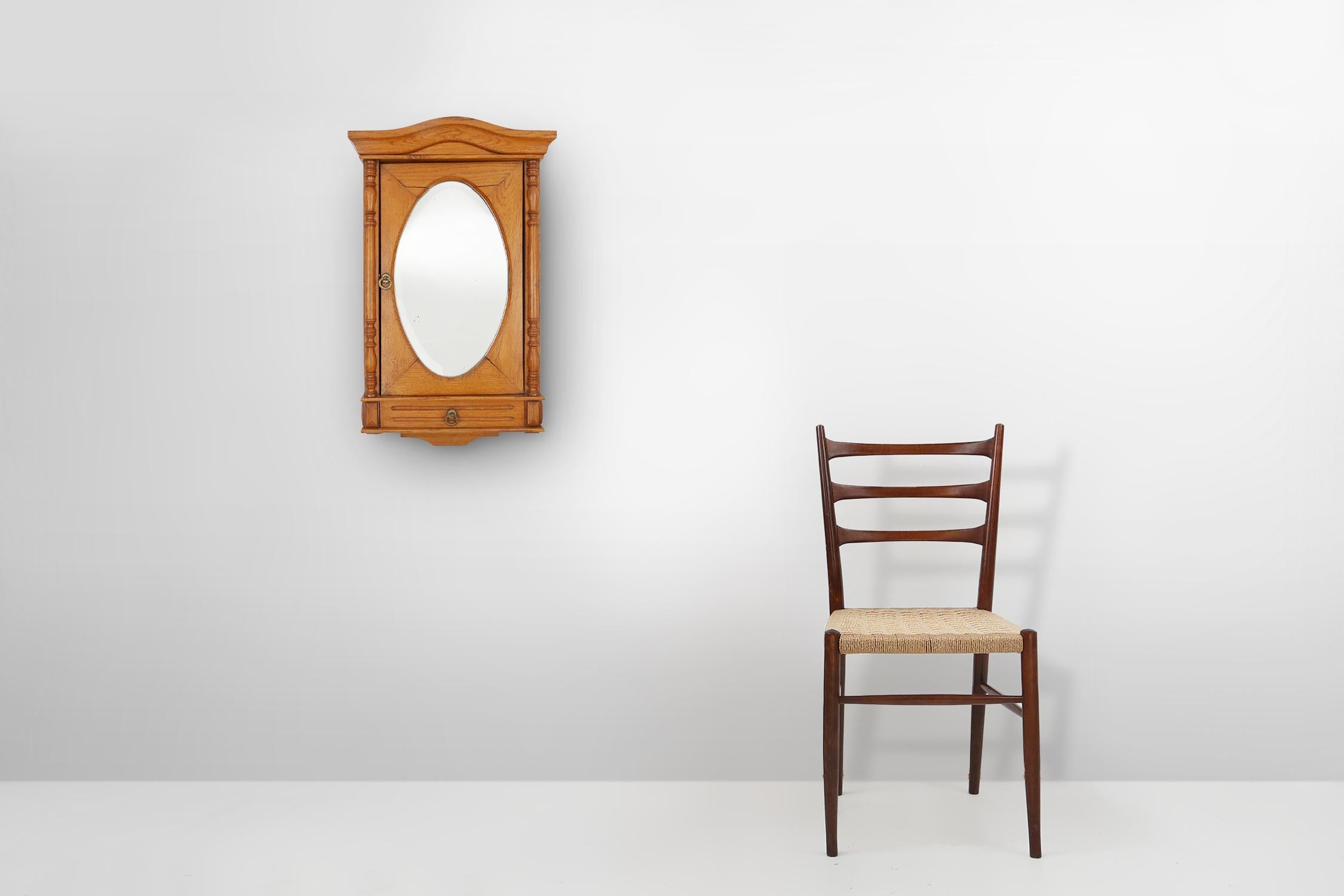 France / 1940 / cabinet de rasage / chêne, miroir / Art Déco 

Cabinet de rasage français richement décoré, fabriqué en chêne blond dans les années 1940. Avec un petit tiroir en bas et une étagère derrière la porte avec miroir ovale biseauté. Les