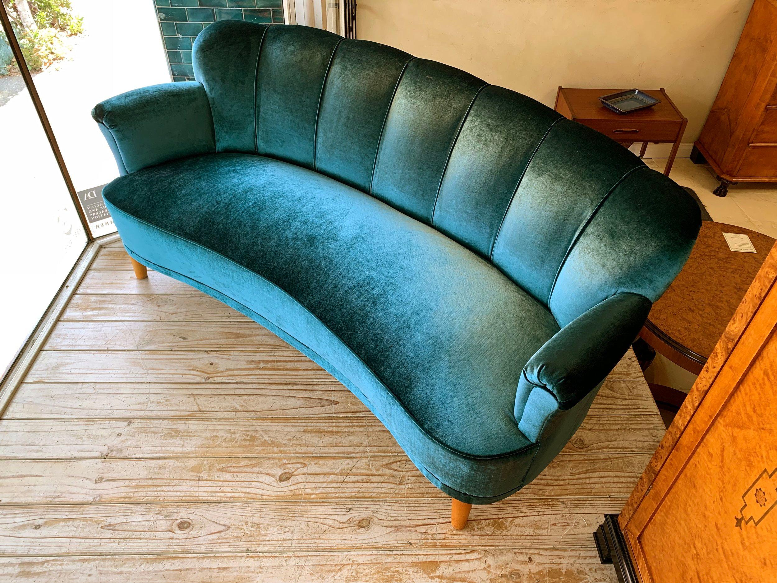 Swedish Art Deco curved shell back sofa with fully sprung seat and back. Reupholstered in a beautiful Peacock color chenille fabric. A very comfortable sofa with timeless elegance.

Date circa 1930

Item D320.



 
