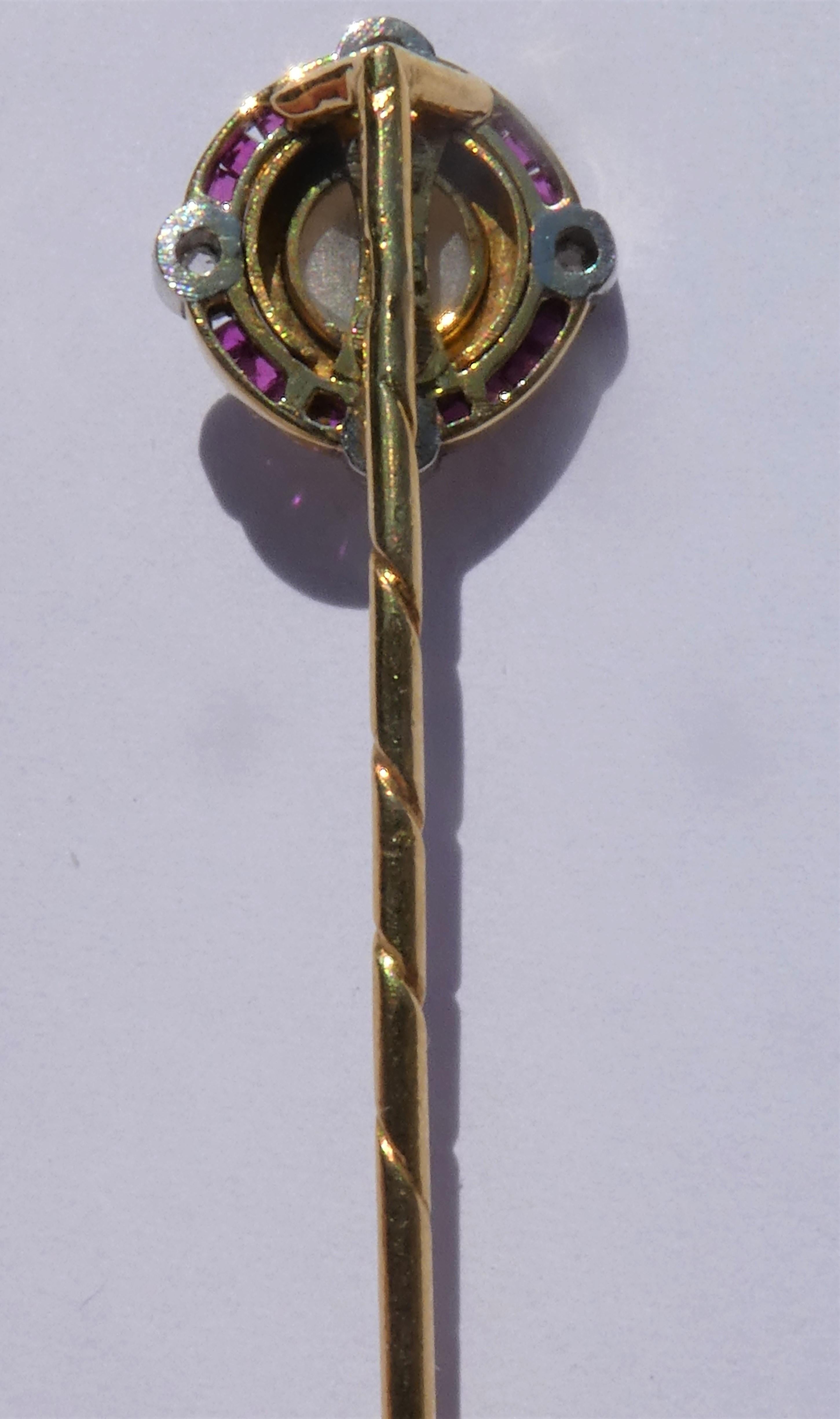 The center of this stickpin features a round small cream white colour shell cameo with an intricately carved image of a lady in profile. The pin was crafted circa 1910 in Europe in 18 karat gold. Around the cameo there is a gold setting with