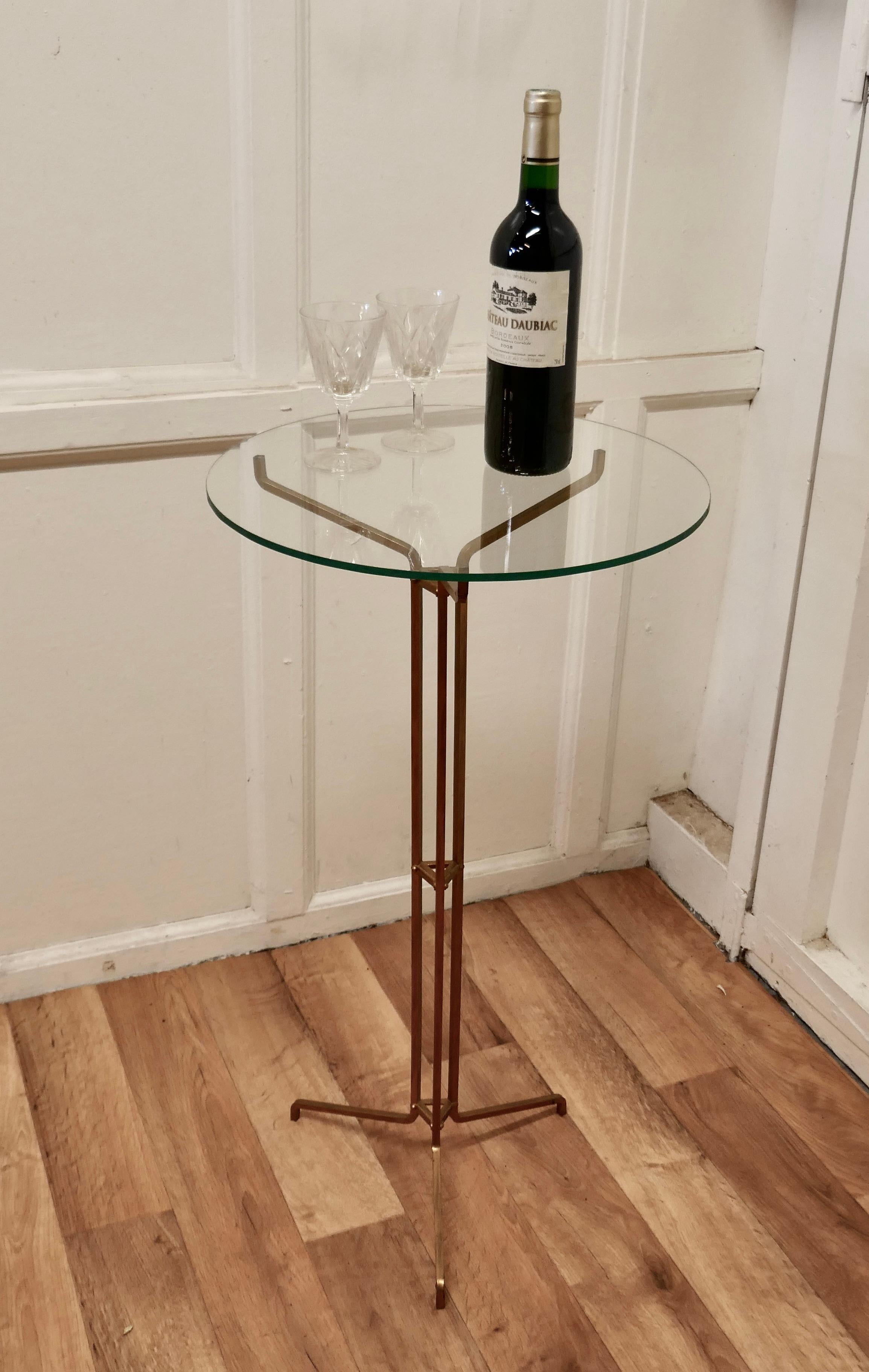 Art Deco Shop Window Display Stand/ Table

This 3 leg stand is made in gilt brass, it has a round glass top so will work as well for a Wine table
It can be used for displaying many different types of articles, from scarves to jewellery and many