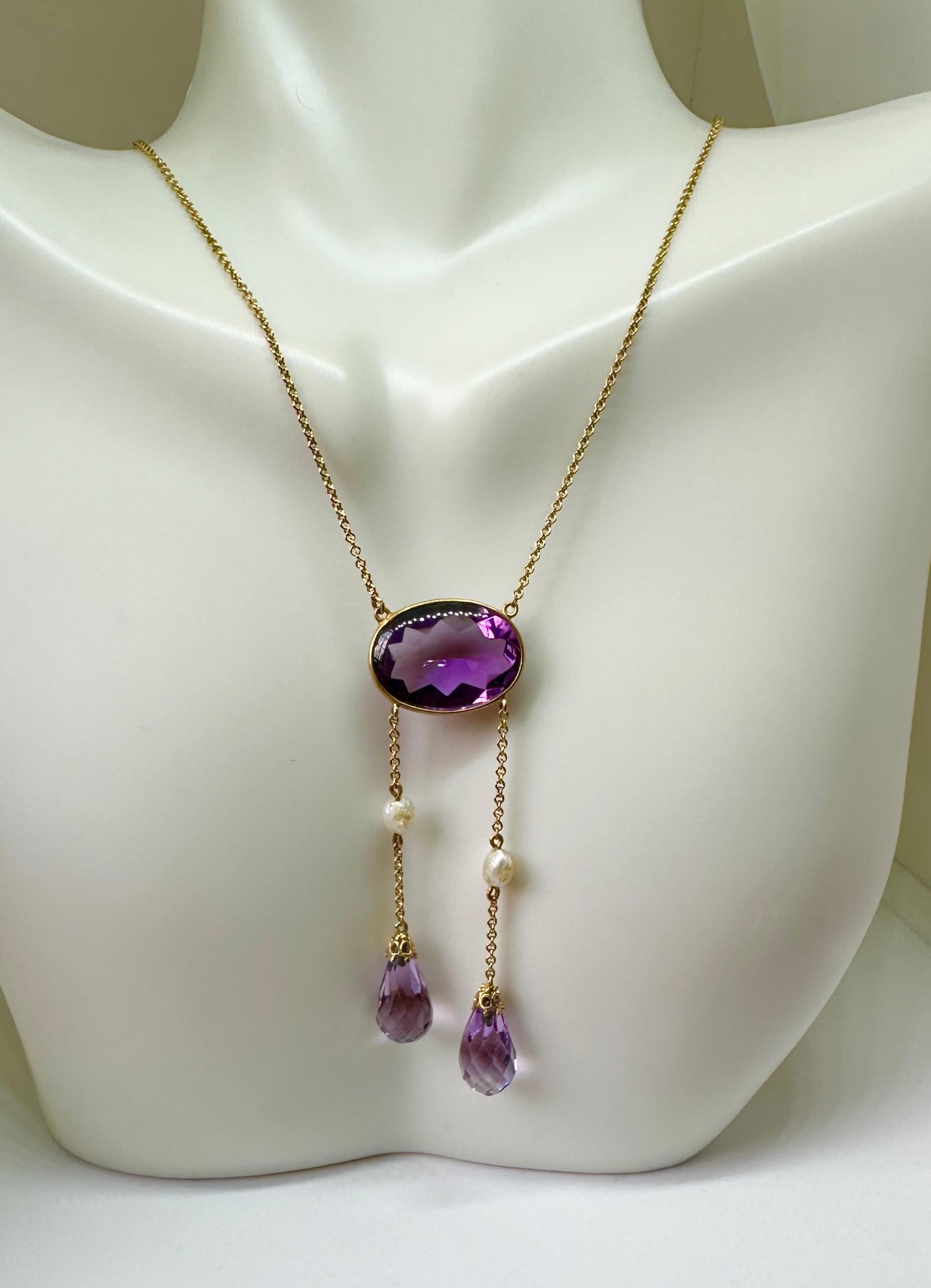 INDULGE IN A STUNNING ANTIQUE SIBERIAN AMETHYST ART DECO - VICTORIAN NEGLIGEE PENDANT NECKLACE IN 14 KARAT GOLD WITH NATURAL PEARL ADORNMENTS.  THE STUNNING PENDANT NECKLACE HAS A CENTRAL OVAL AMETHYST OF EXTRAORDINARY COLOR AND CUT WITH TWO