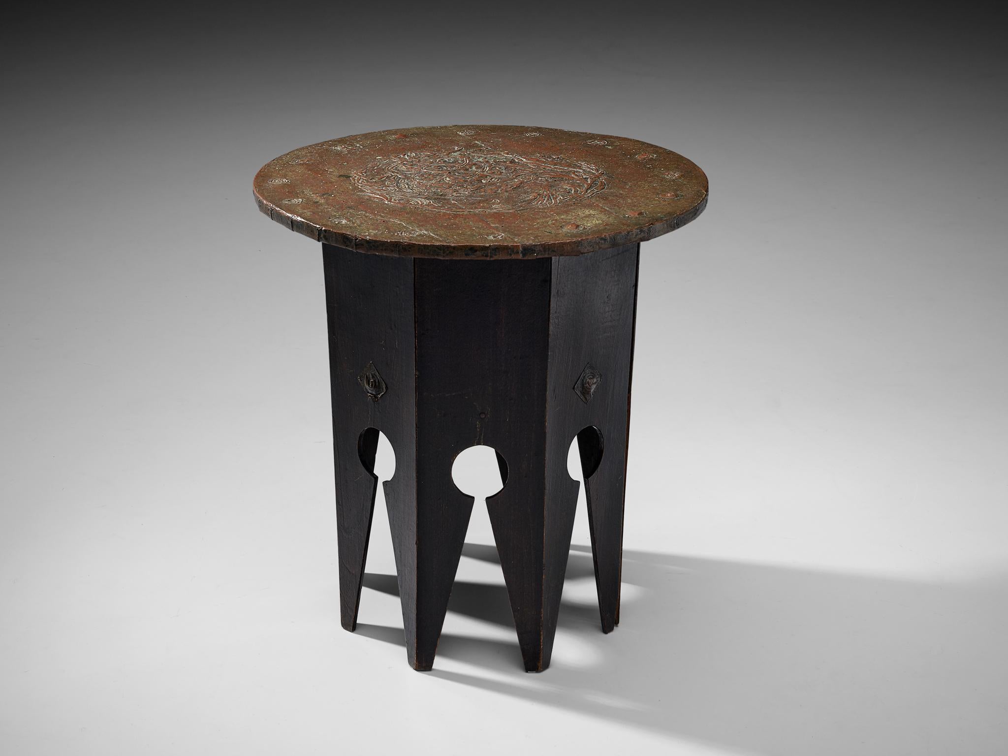 Side table, wood, copper, Nothern Europe, 1920s

With the unique shape of the legs and thin layered copper this coffee table is a rare to find design. The black wooden base of the table consists out of a polygonal base with tapered legs. Each slat