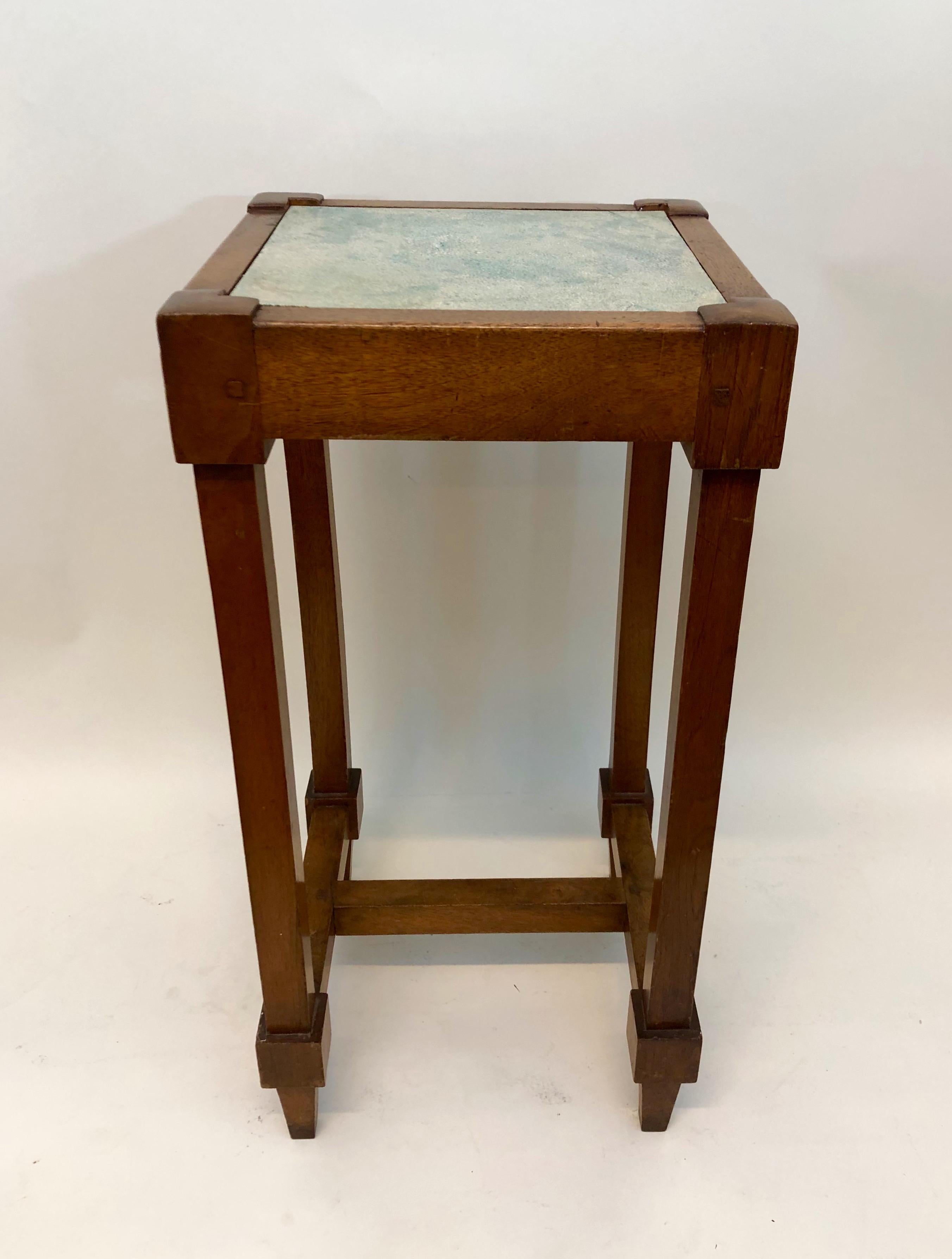 This small side table was made from two materials that are rarely combined: red oak which is commonplace, and shagreen which is rare. Shagreen is the hide of the stingray. It's leather-like, but more durable, and interesting-looking, with a natural