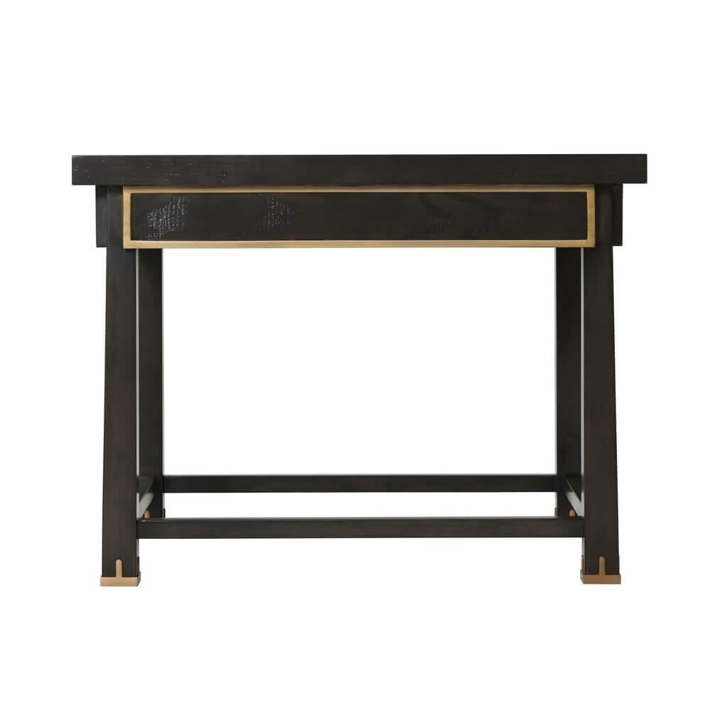 Art Deco style ash veneered rectangular side table with a relief paneled frieze having gilt highlights, raised on reverse tapered legs with bronze finish capping and joined by a stretcher.

Dimensions: 29.5