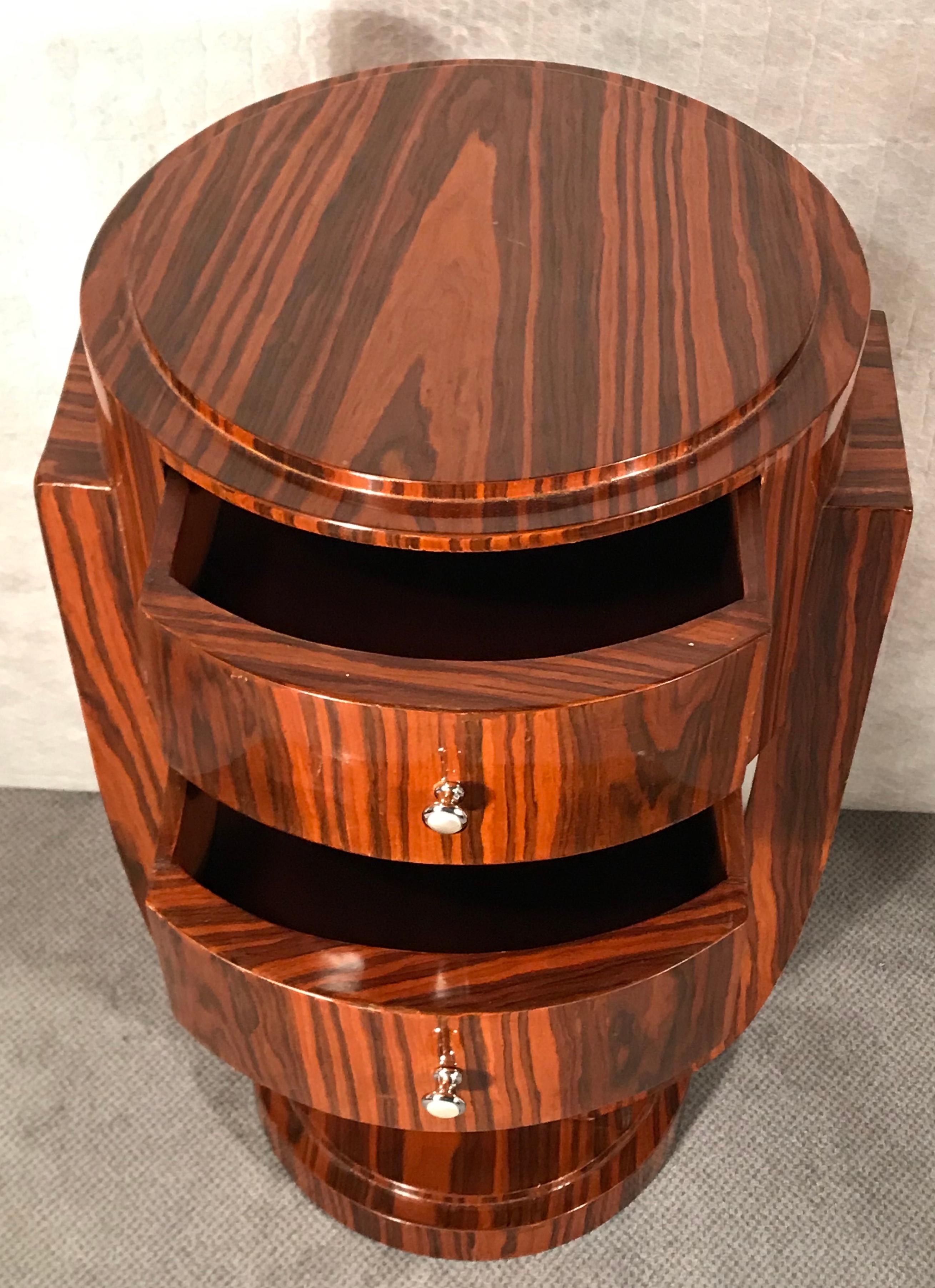 Art Deco side table, France 1920-1930. This beautiful original Art Deco side table was made circa 1920-1930 in France. The elegant design of the two drawer table is embellished with an exquisite Makassar ebony wood veneer.

Art Deco, short for
