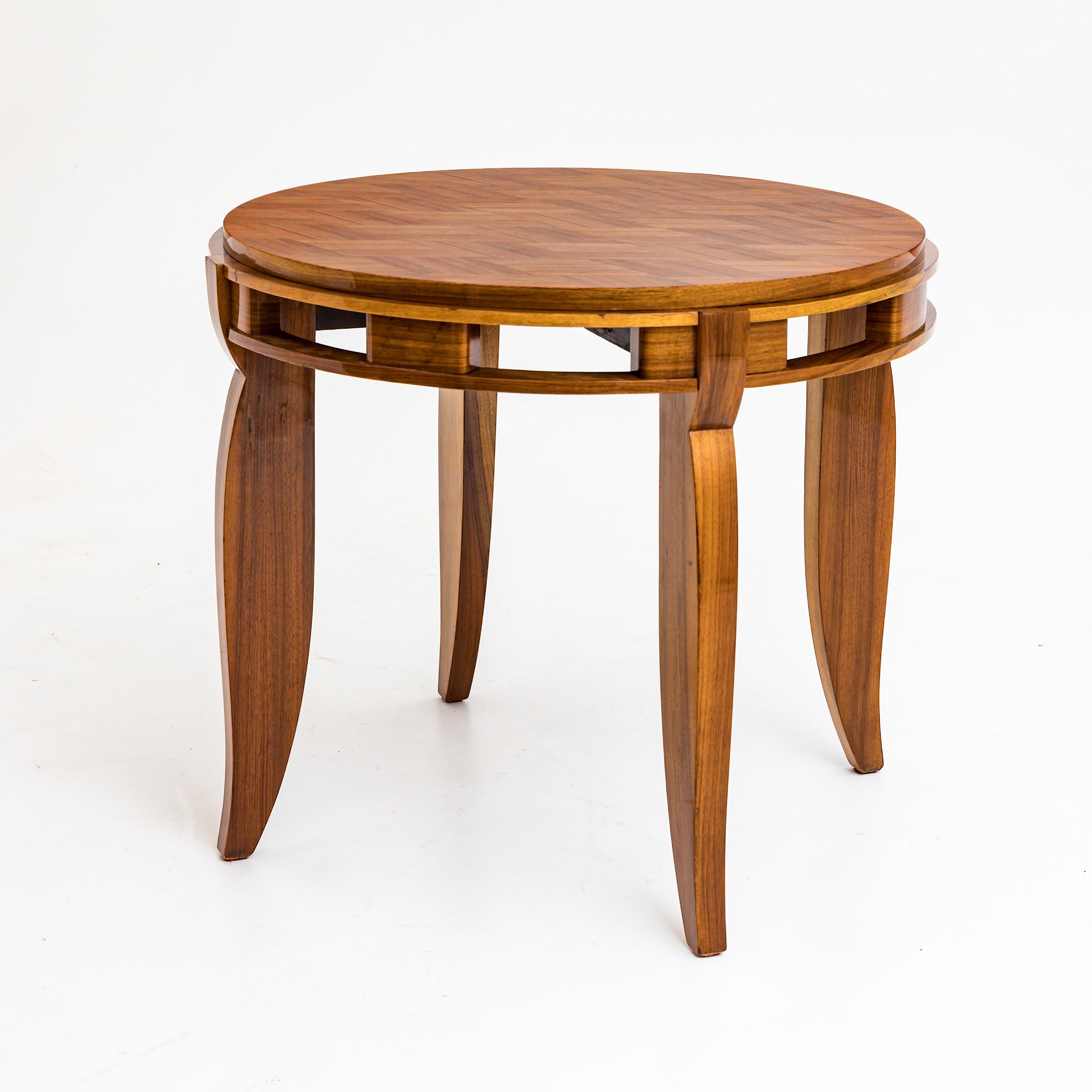 Art Deco side table on slightly curved legs with open-worked frame and round tabletop. The top is parquetted in a diamond shape. The table has been restored and hand polished.