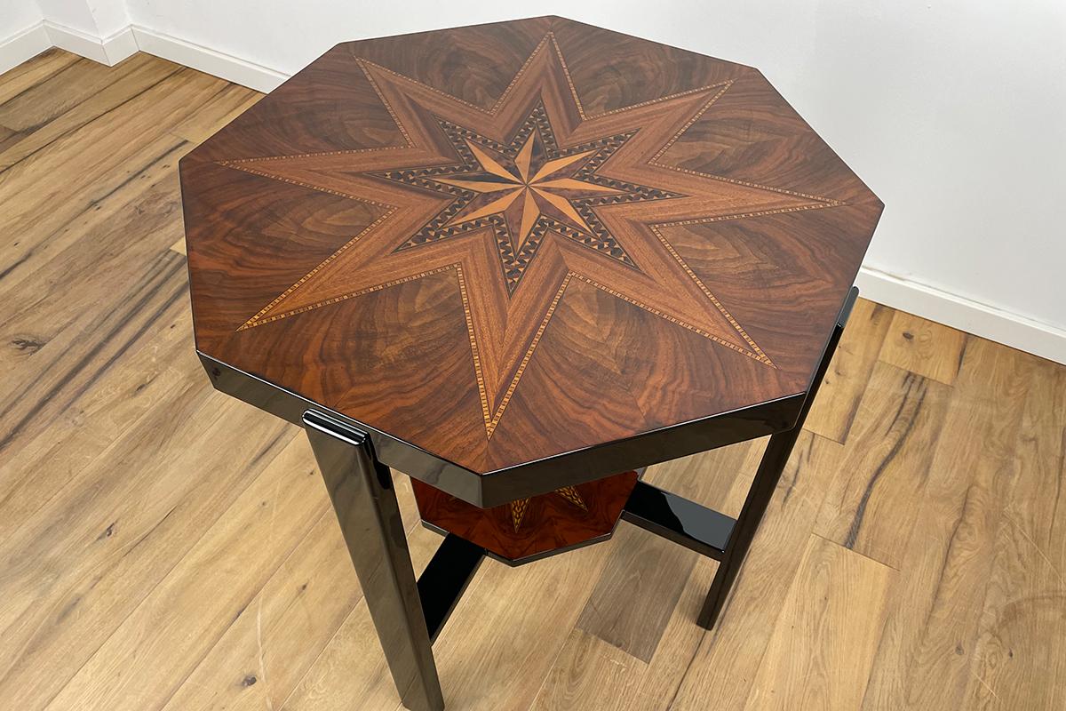 Unique side table with beautiful marquetry work. Walnut, maple, macassar and mahogany have been processed very finely in the inlay work. The table looks incredibly elegant and light with its shape. A very precious and rare French Art Deco table that