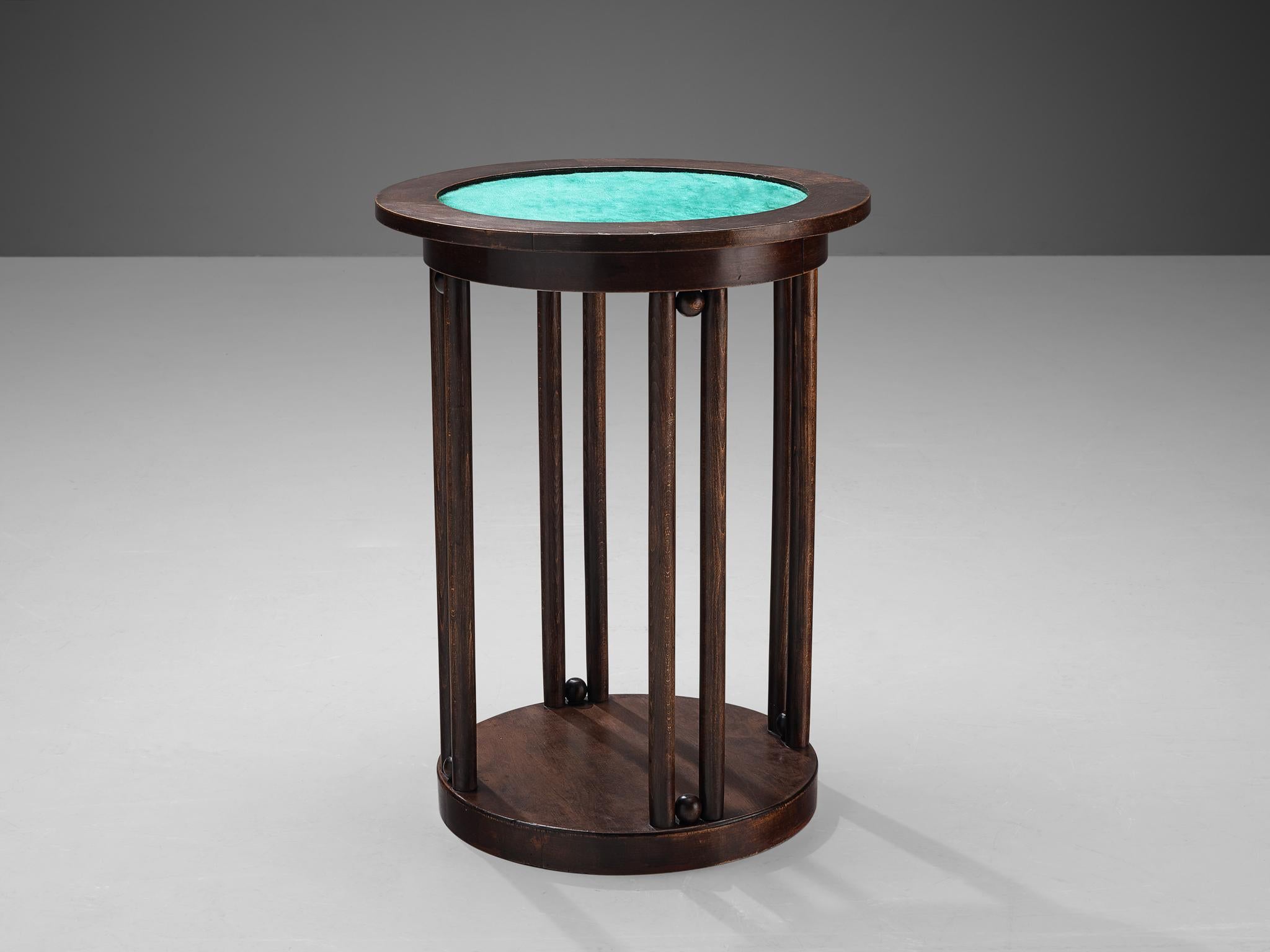 Side table, oak, fabric, Europe, 1930s 

This well-designed side table is architectural in its structure which is established by a round base through which thin, elongated slats develop. Both ends are adorned with round, small spheres which make